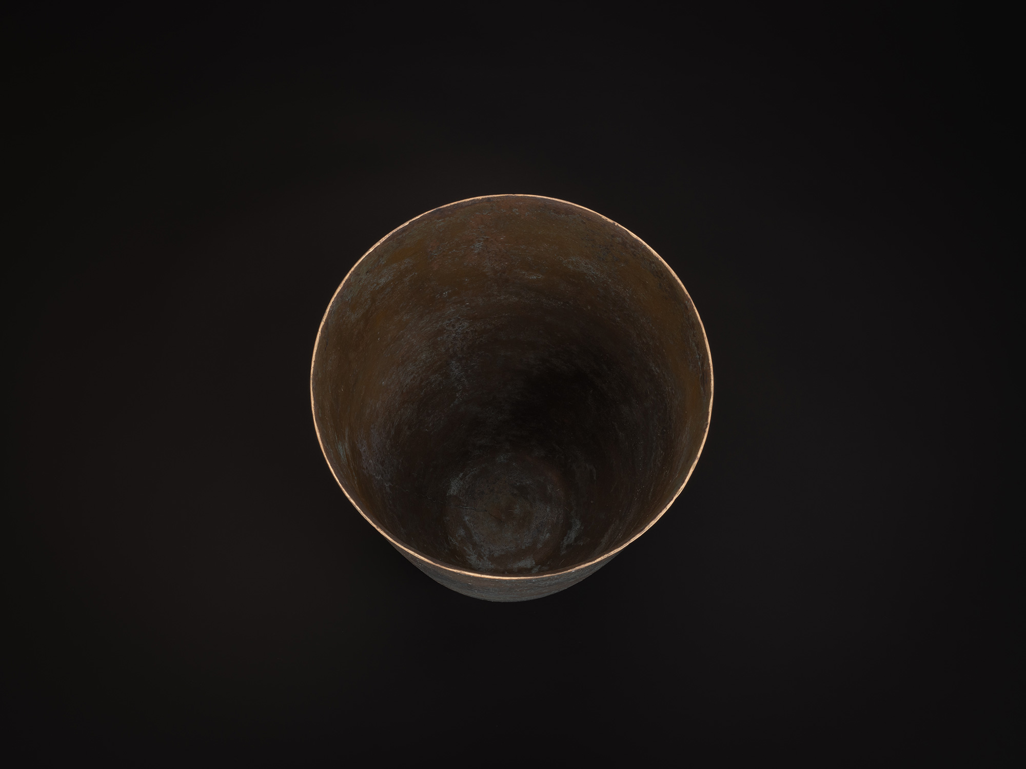 Top-down view of Bronze No. 1 by Hatakeyama, showing a circular opening with a thin, slightly irregular...