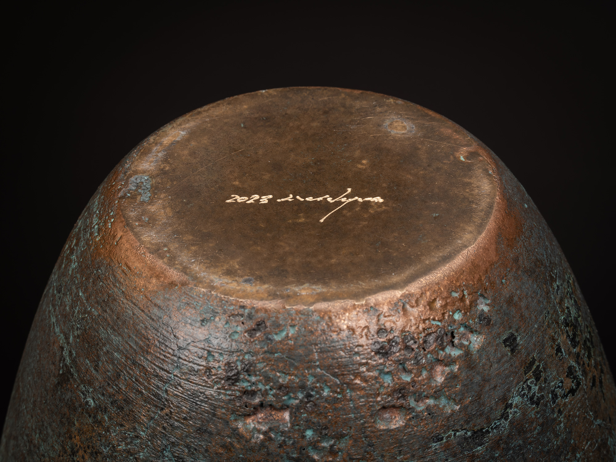 Underside view of Bronze No. 1 by Hatakeyama, showing a flat, circular base with a slightly raised...