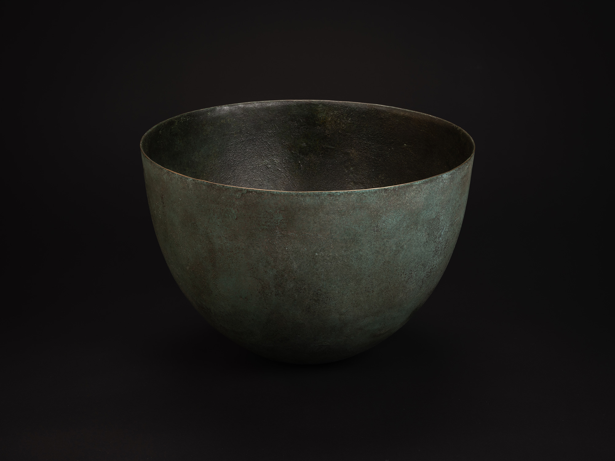 Rounded bronze vessel titled Bronze No. 18 by Hatakeyama, with a wide, open mouth and smooth, gently...