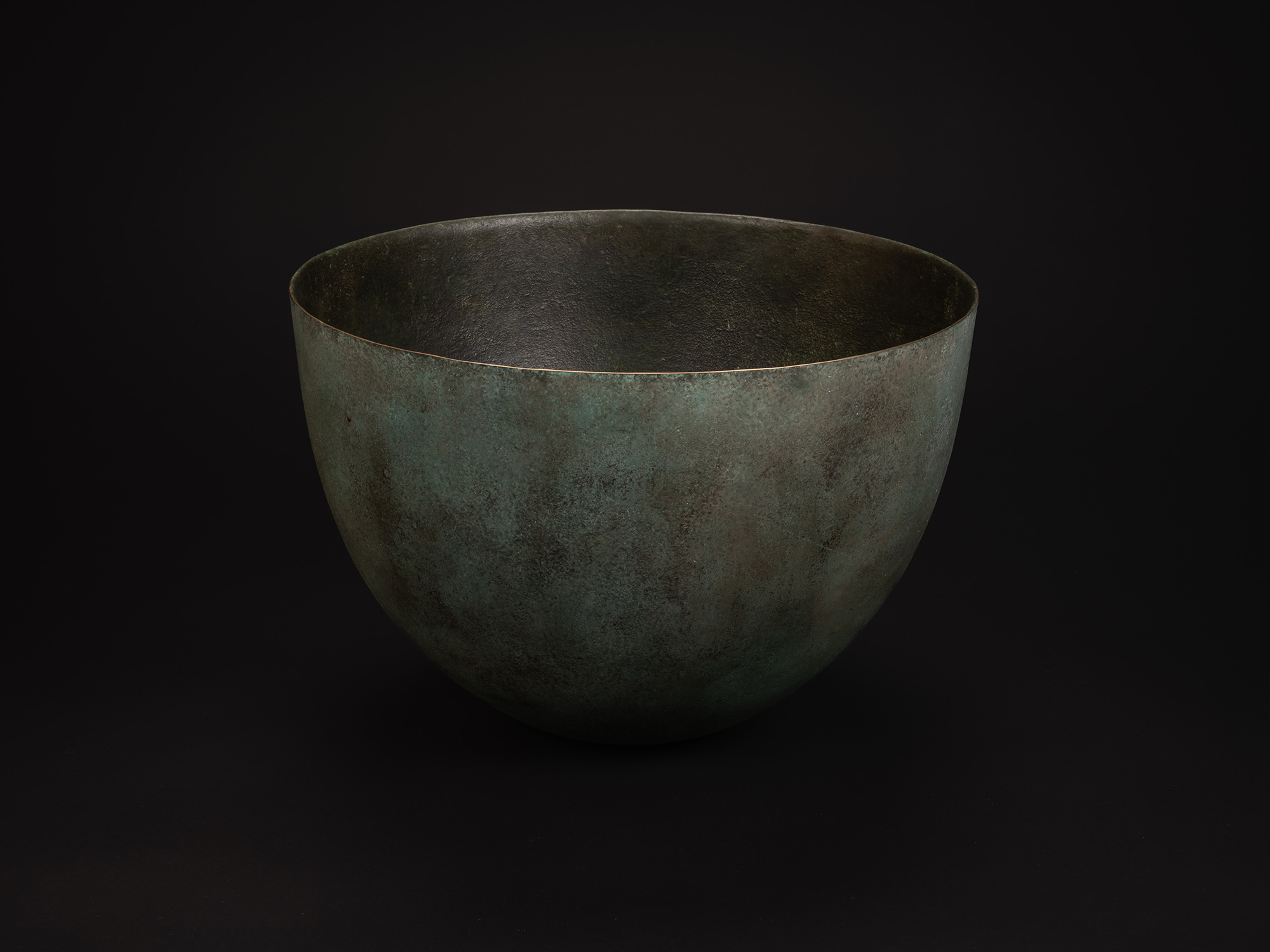 Rounded bronze vessel titled Bronze No. 18 by Hatakeyama, with a wide, open mouth and smooth, gently...