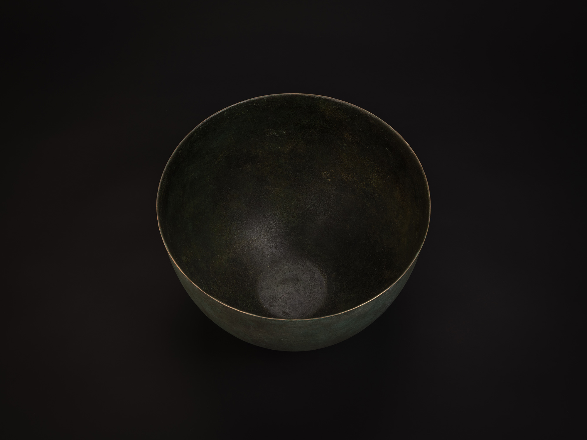 Aerial view of Bronze No. 18 by Hatakeyama, showing a wide circular opening with a thin, even rim....
