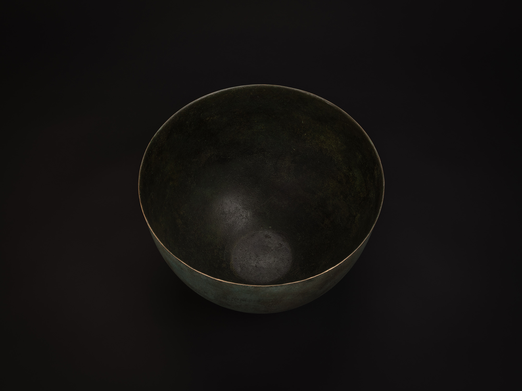 Aerial view of Bronze No. 18 by Hatakeyama, showing a wide circular opening with a thin, even rim....
