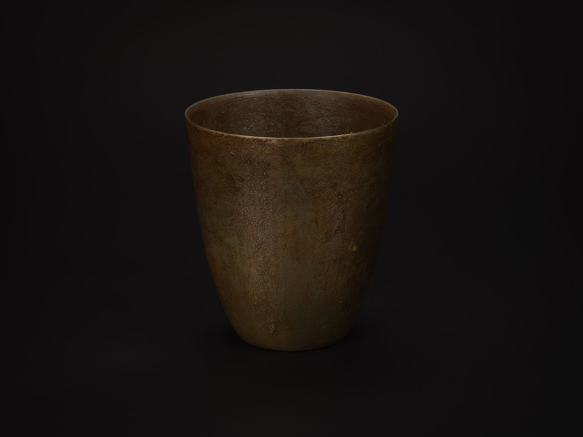 Bronze vessel by Koji Hatakeyama with a tall, tapered form and a wide circular rim. The sides slope...
