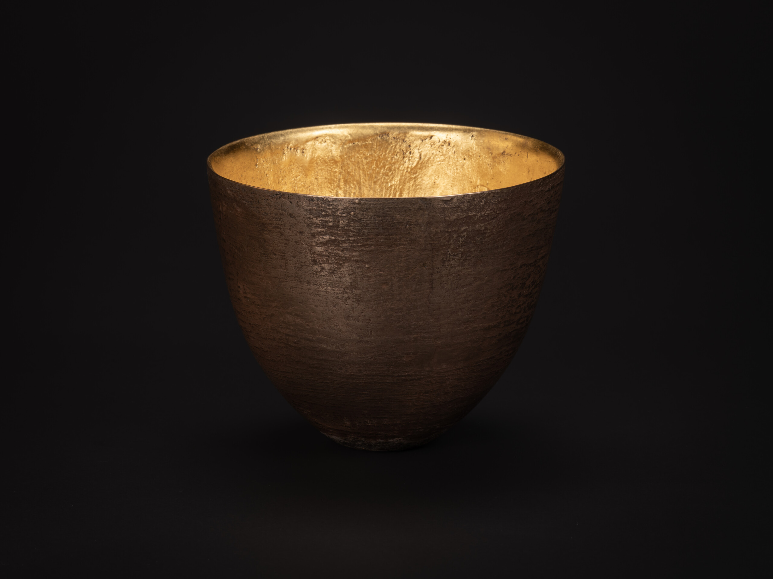 Bronze bowl by Koji Hatakeyama with a wide circular rim and gently curved sides tapering toward...