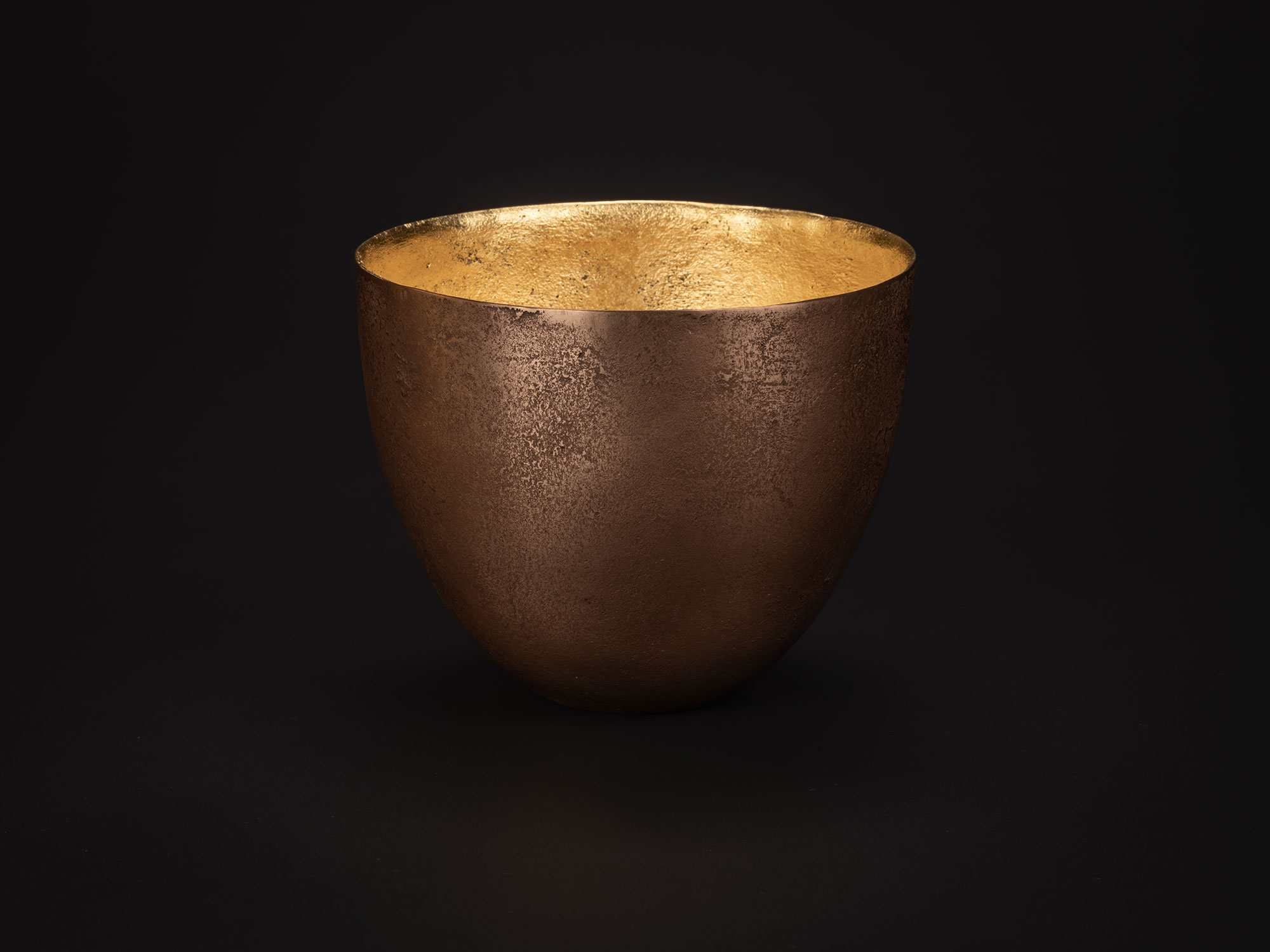 Bronze bowl by Koji Hatakeyama with a wide circular rim and rounded sides tapering toward a small...