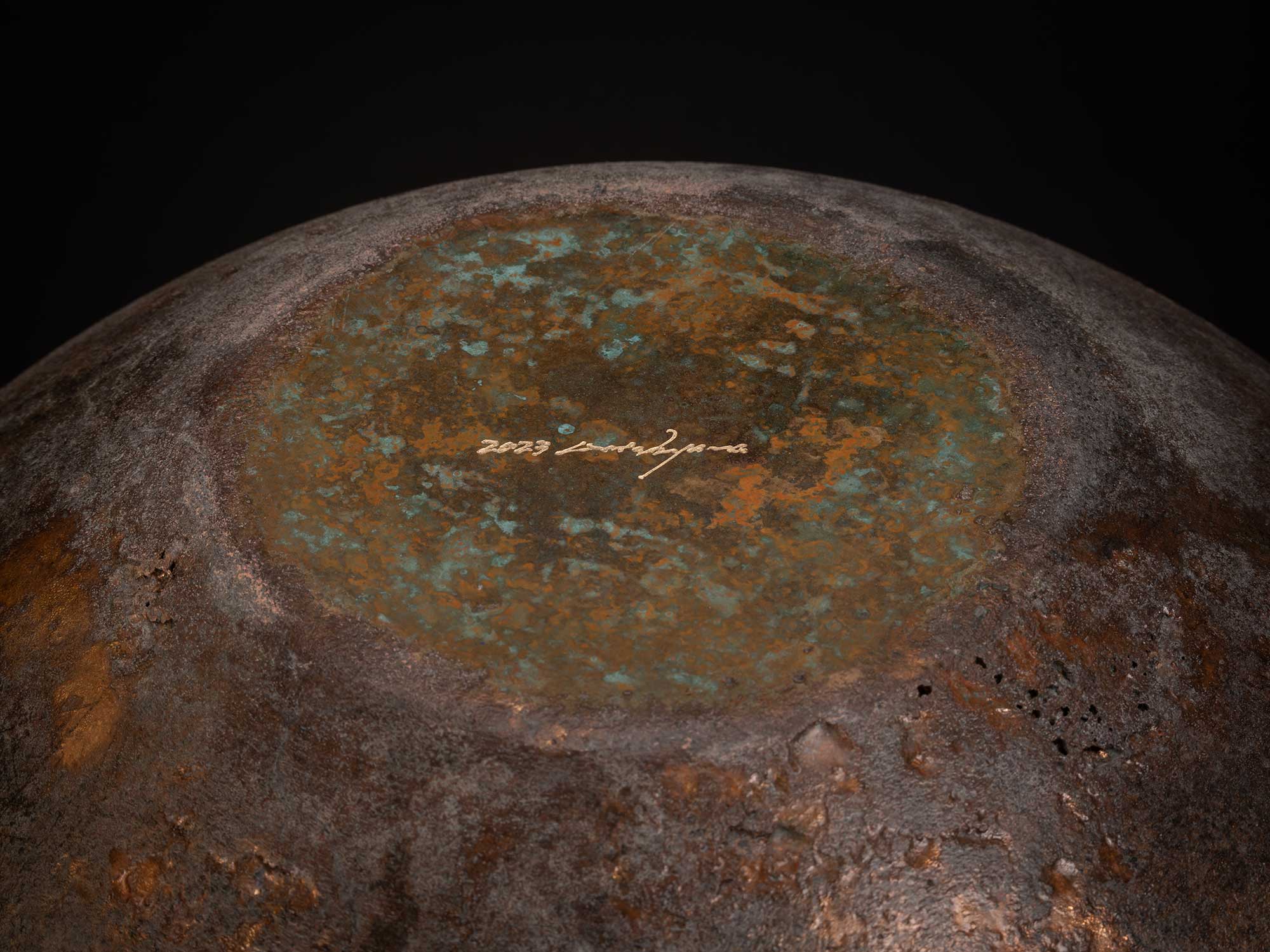 Base of Bronze No. 2 by Koji Hatakeyama, showing the underside of the bronze vessel with a circular...