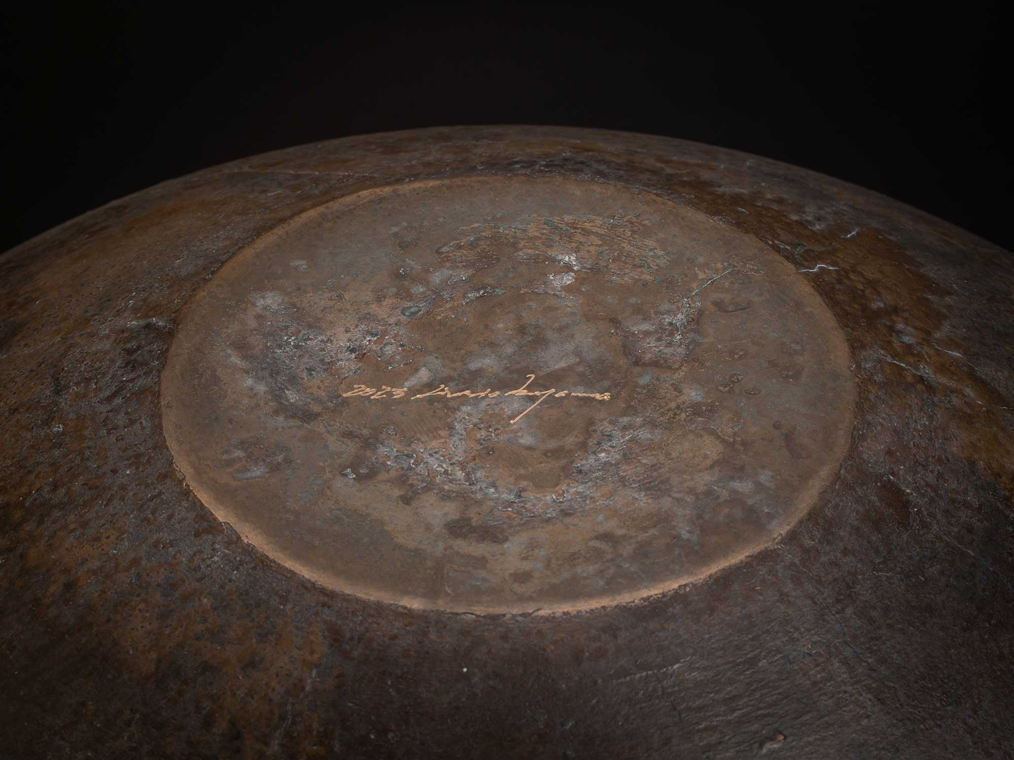 Underside of Bronze No. 24 by Hatakeyama, 2023, showing a circular foot with a weathered bronze...