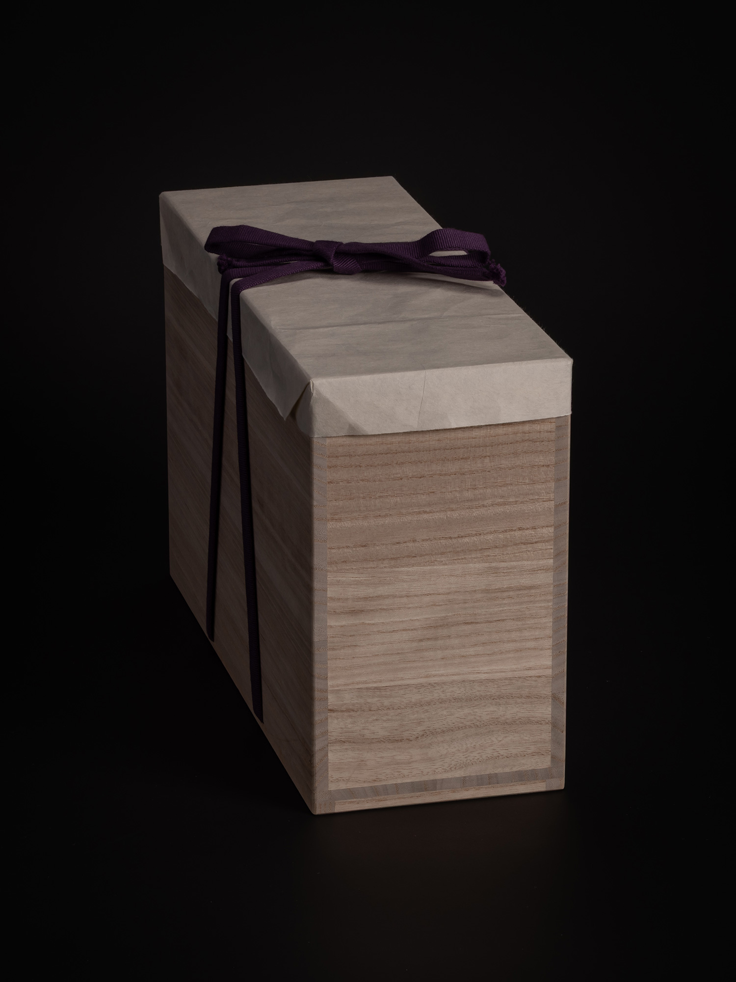 Wooden tomobako storage box for Faceted Covered Vessels by Akira Yagi, wrapped in white protective...