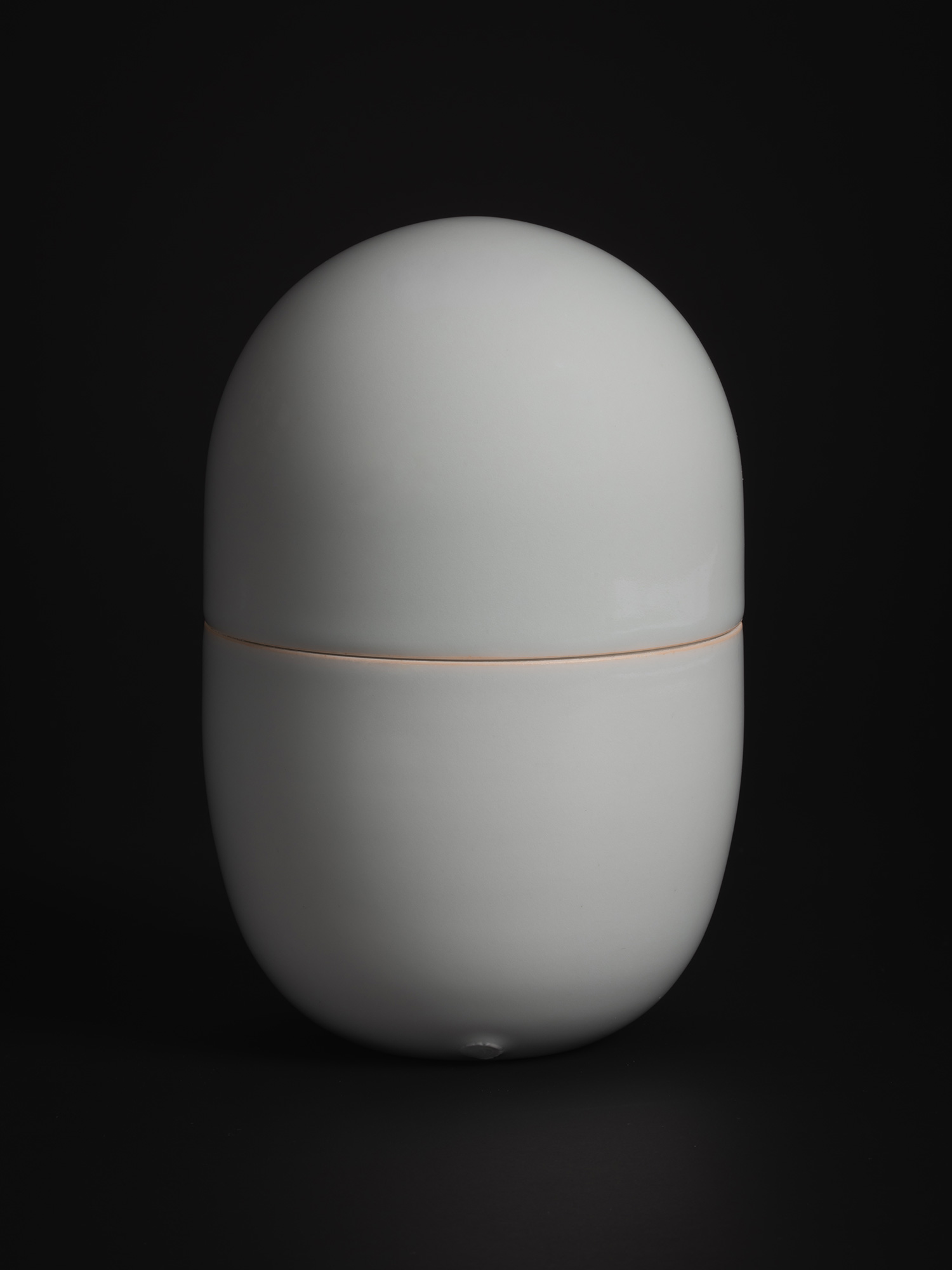 A front-facing studio photograph of a single large porcelain container from Akira Yagi’s Nesting...