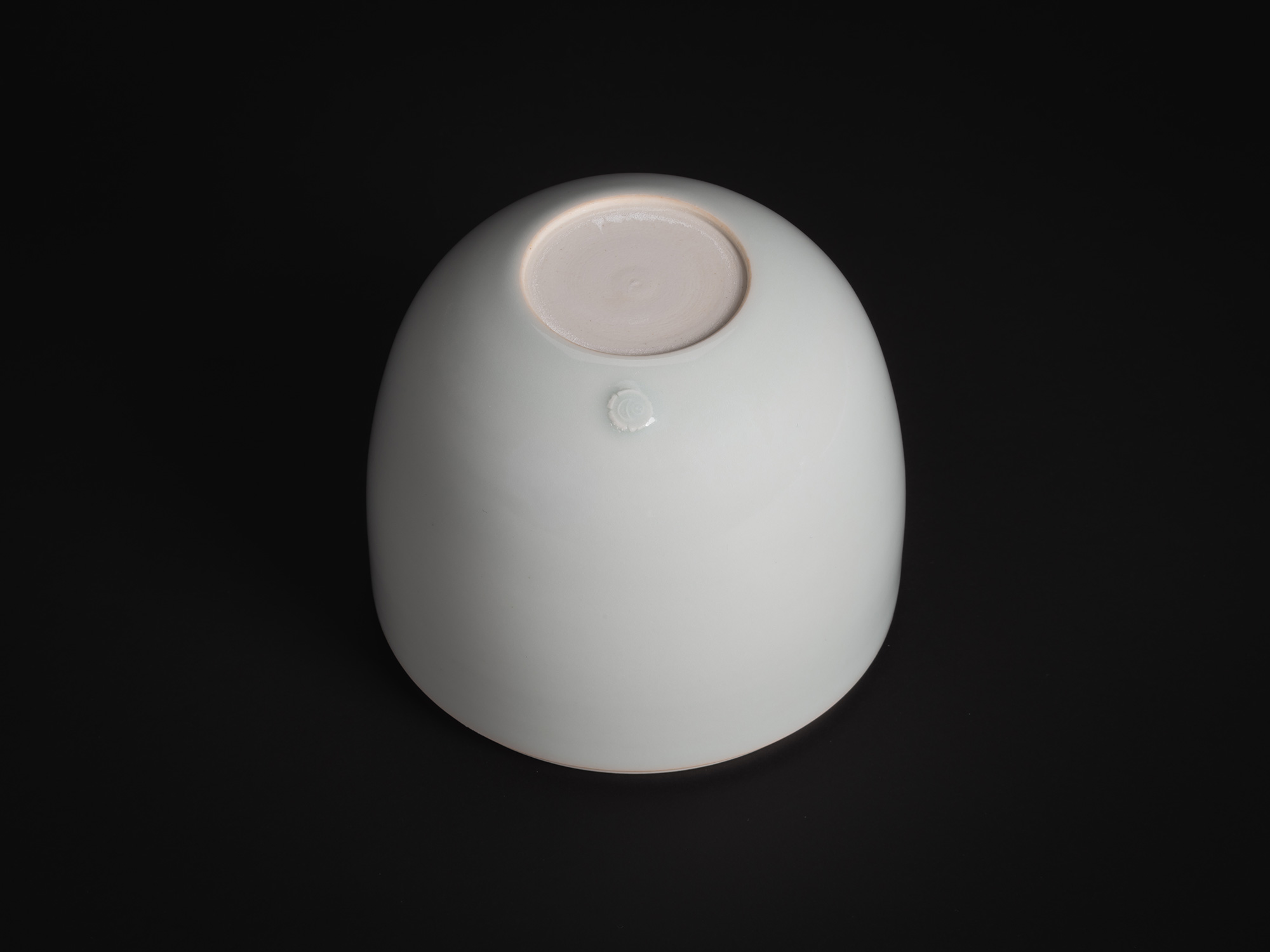 A high-angle studio photograph of the base of a porcelain vessel from the Nesting Covered Boxes...