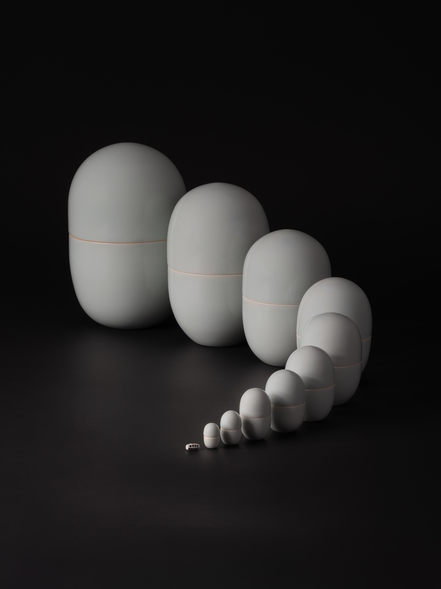 A minimalist photograph of Nesting Covered Boxes by Japanese ceramic artist Akira Yagi. The artwork...