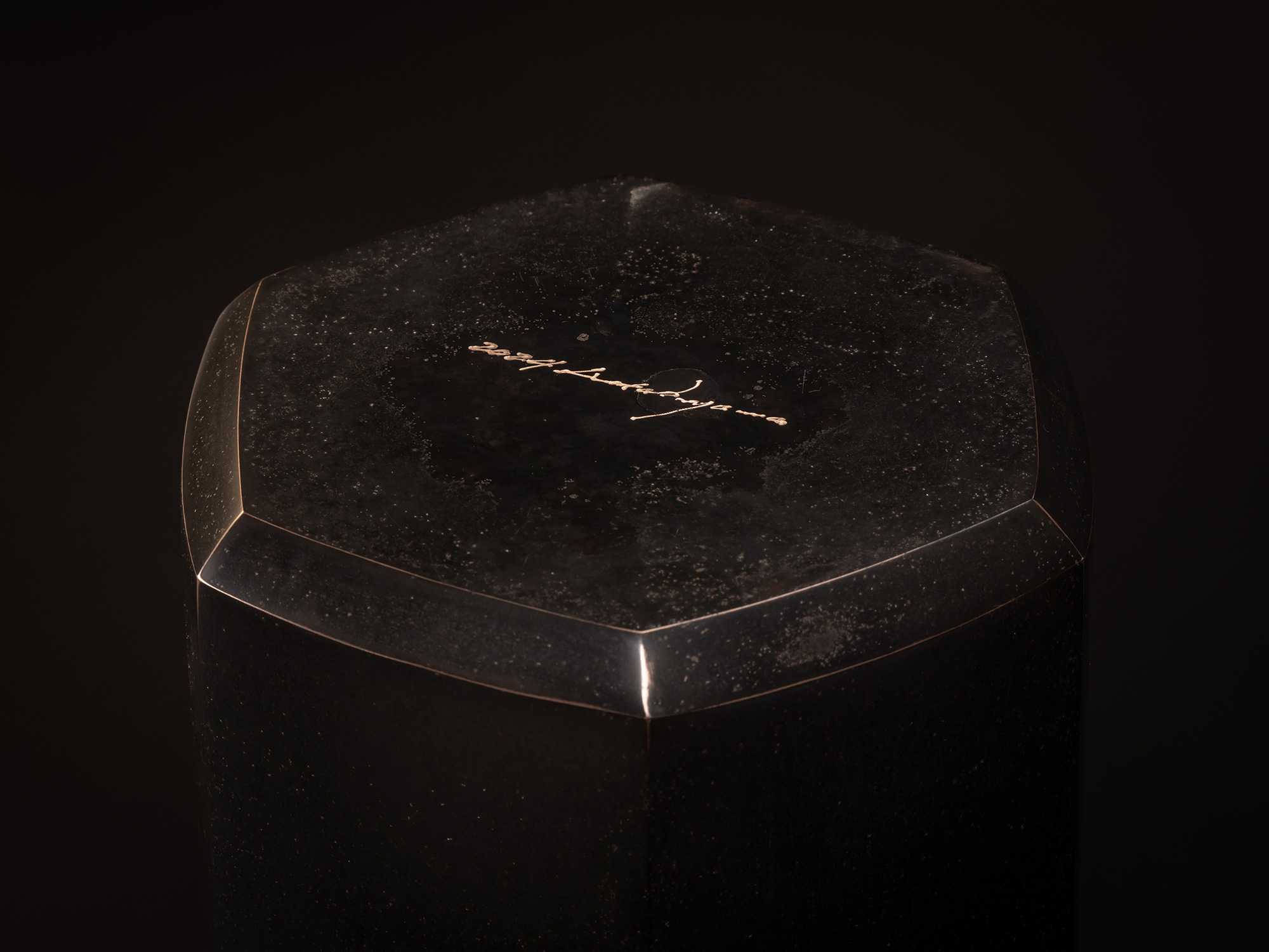 Koji Hatakeyama, Six Faces, 2024. Angled view of the hexagonal top of a faceted bronze vessel,...