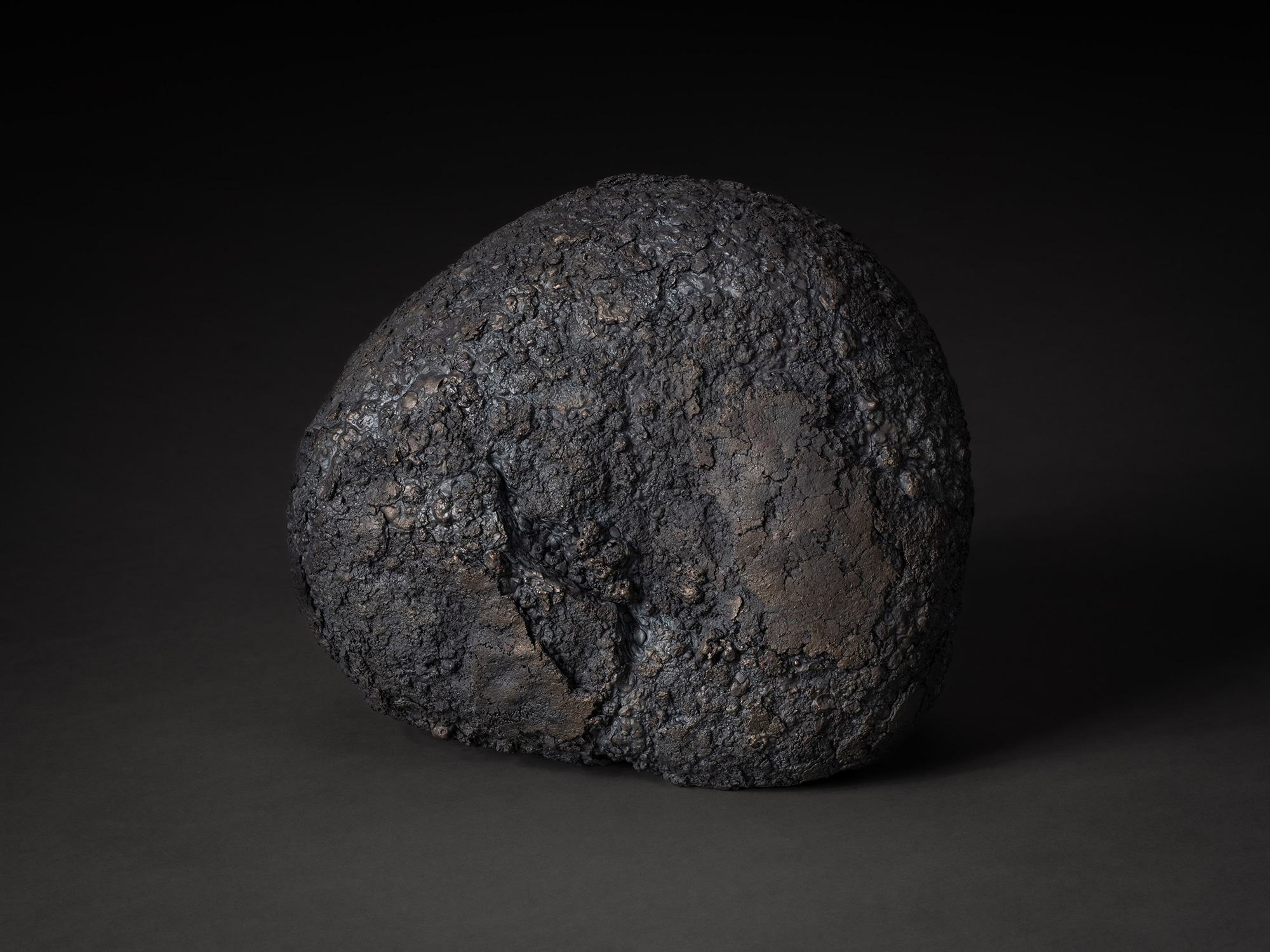 Depth of Fusion by Aki Rusu, a compact, rounded iron sculptural form with an irregular, asymmetrical...