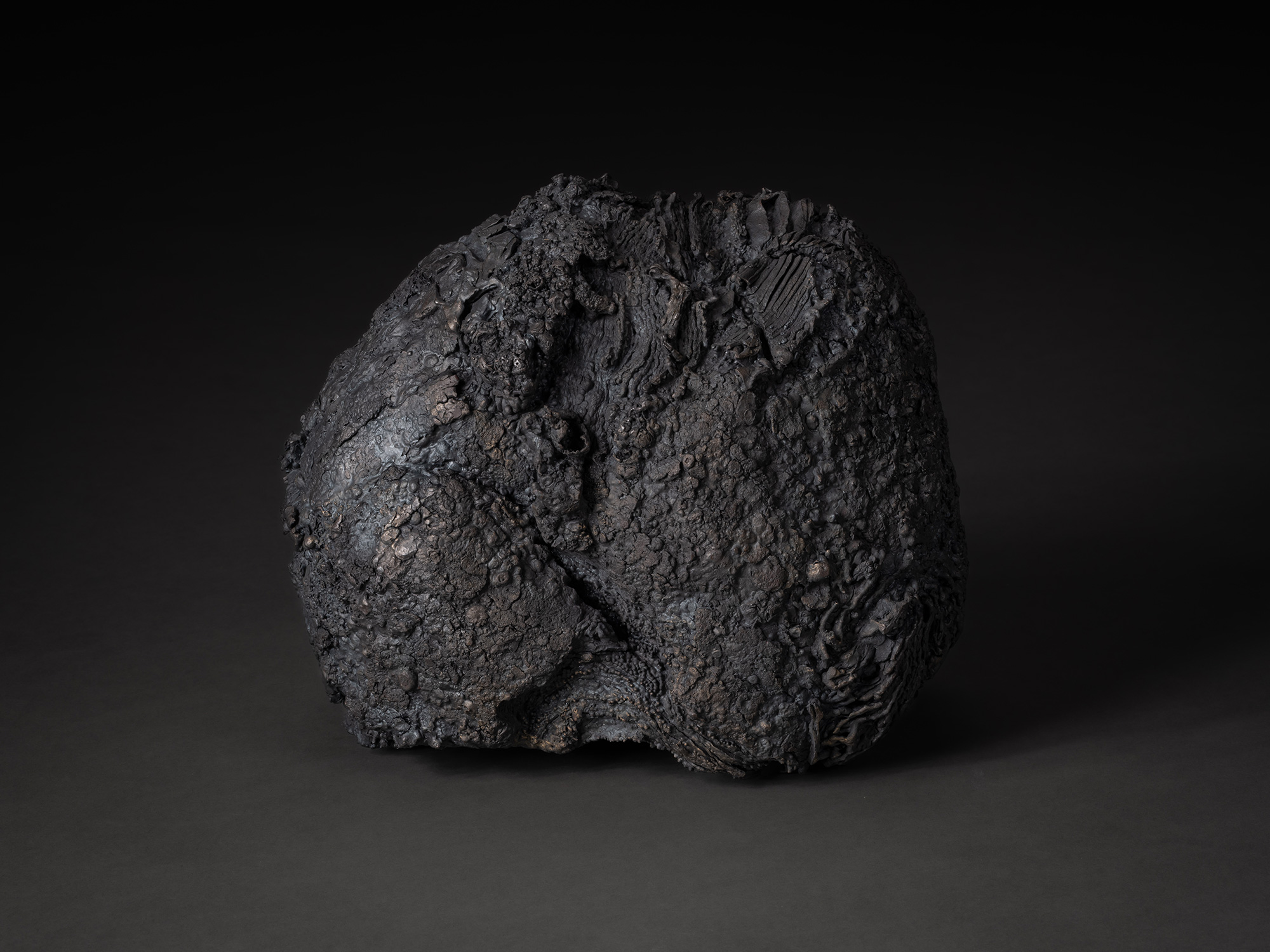 Depth of Fusion by Aki Rusu, a compact, rounded iron sculptural form with an irregular silhouette...