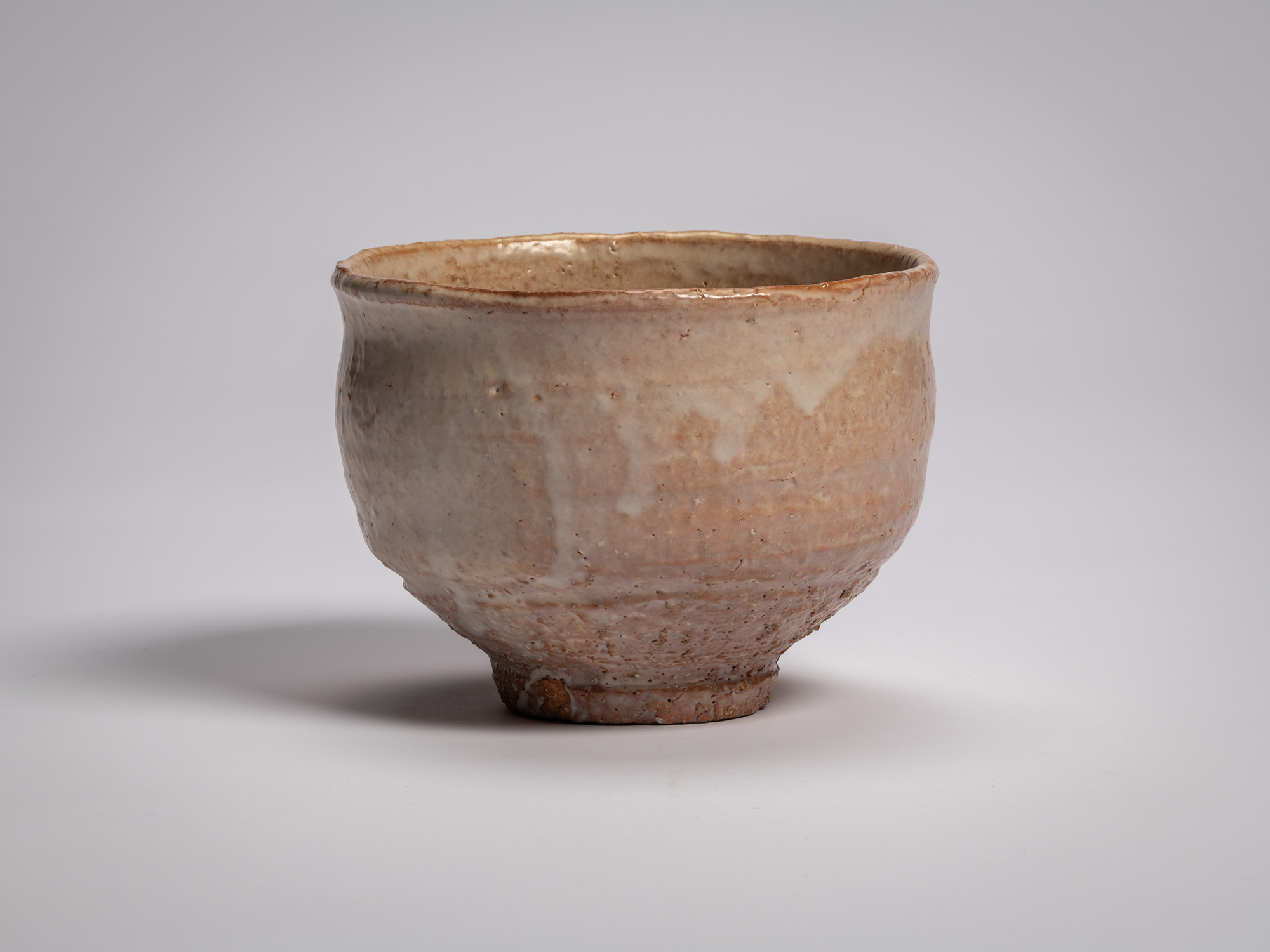 Hagi chawan (tea bowl) by Miwa X, a rounded ceramic bowl with a gently flared rim and slightly...