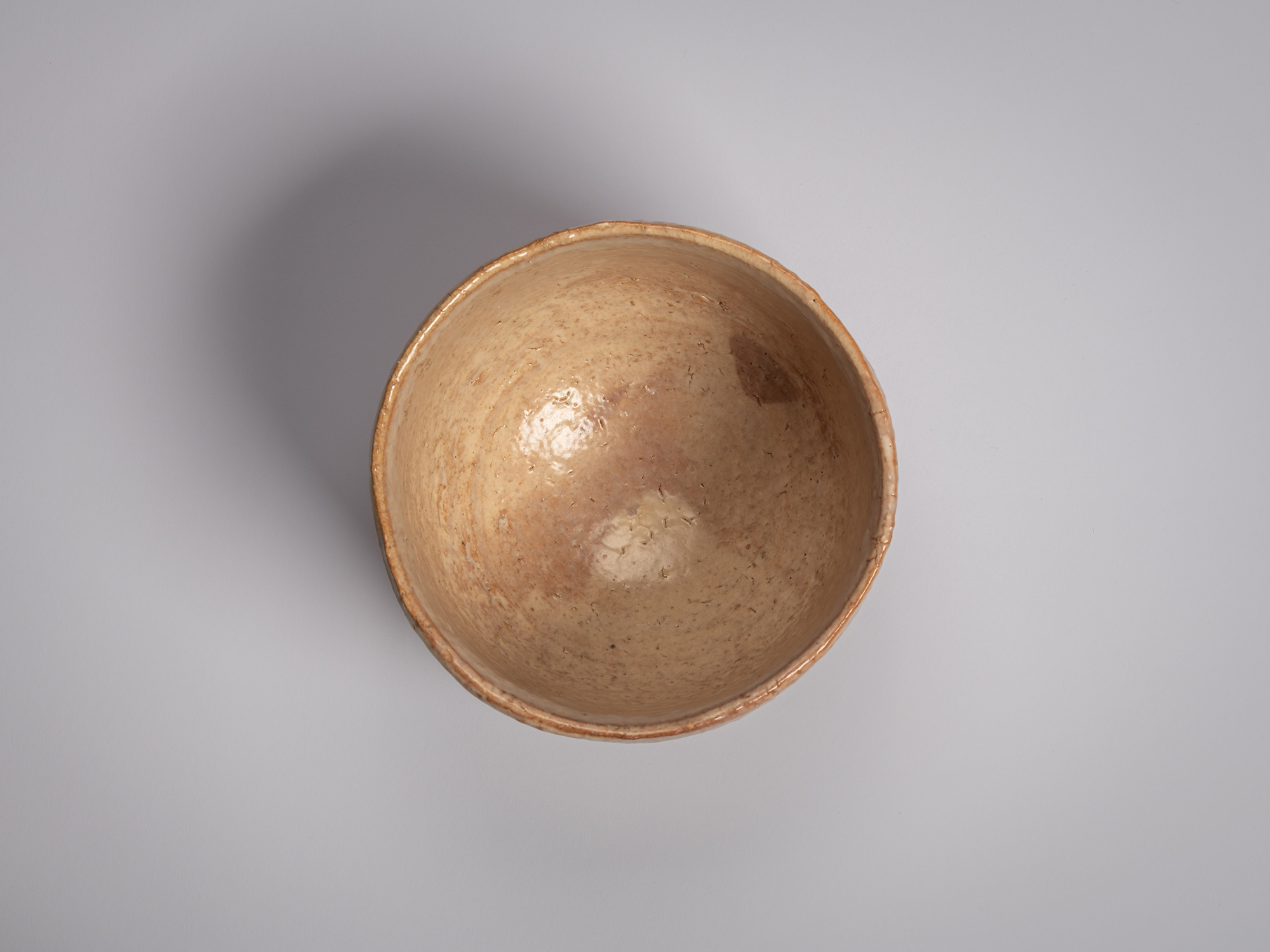 Interior view of a Hagi chawan by Miwa X, showing a rounded bowl with a gently sloping interior...