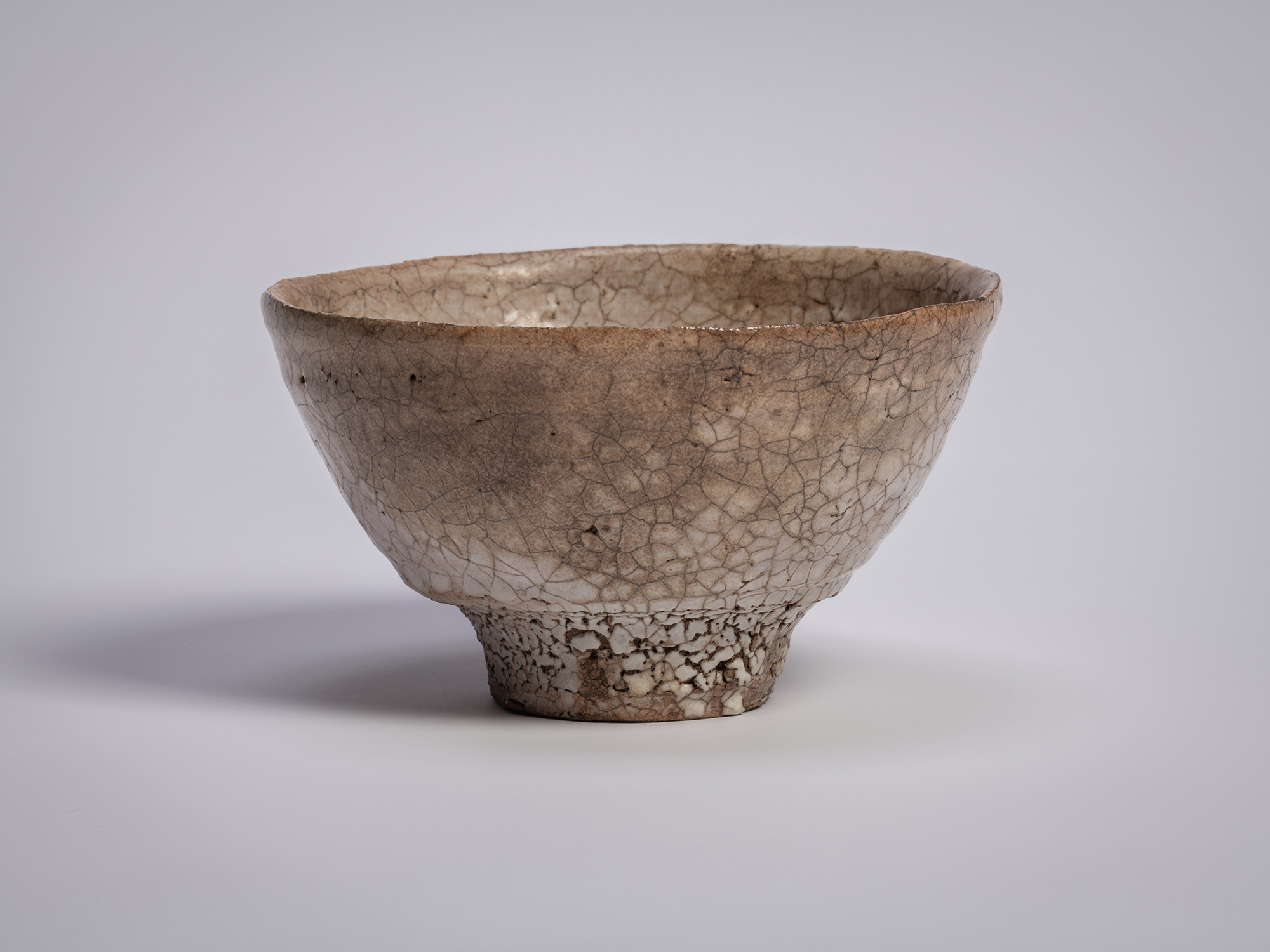 Ido chawan tea bowl by Tsujimura, with an asymmetrical, hand-formed shape, earthy clay body, and...