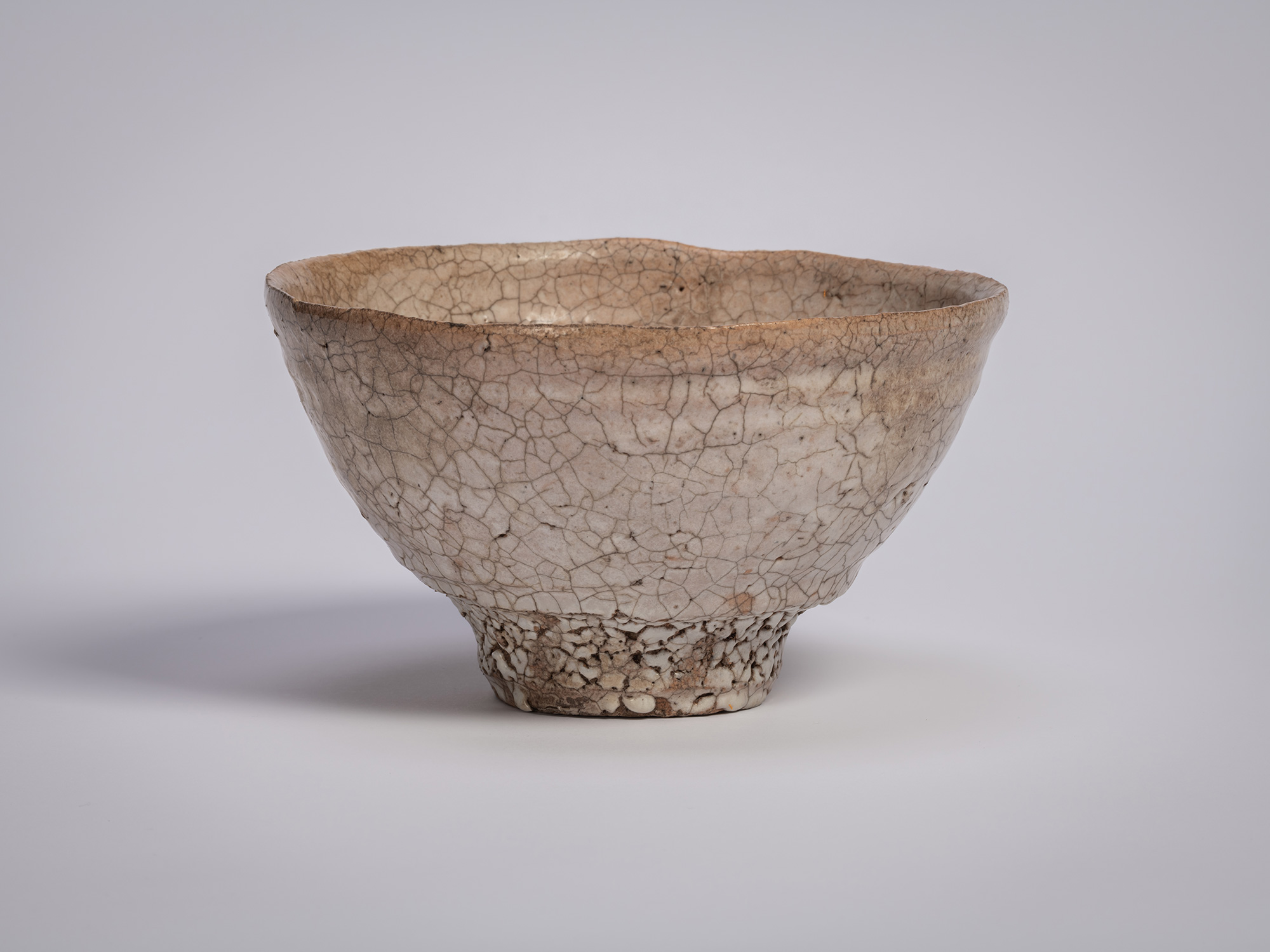 Ido chawan tea bowl by Tsujimura, with an asymmetrical, hand-formed shape, earthy clay body, and...