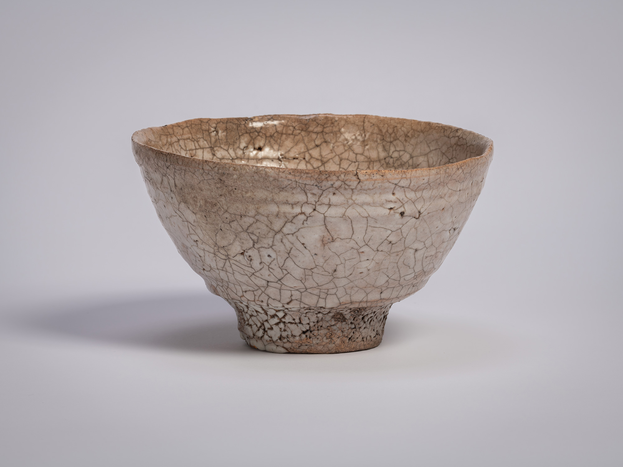 Ido chawan tea bowl by Tsujimura, with an asymmetrical, hand-formed shape, earthy clay body, and...