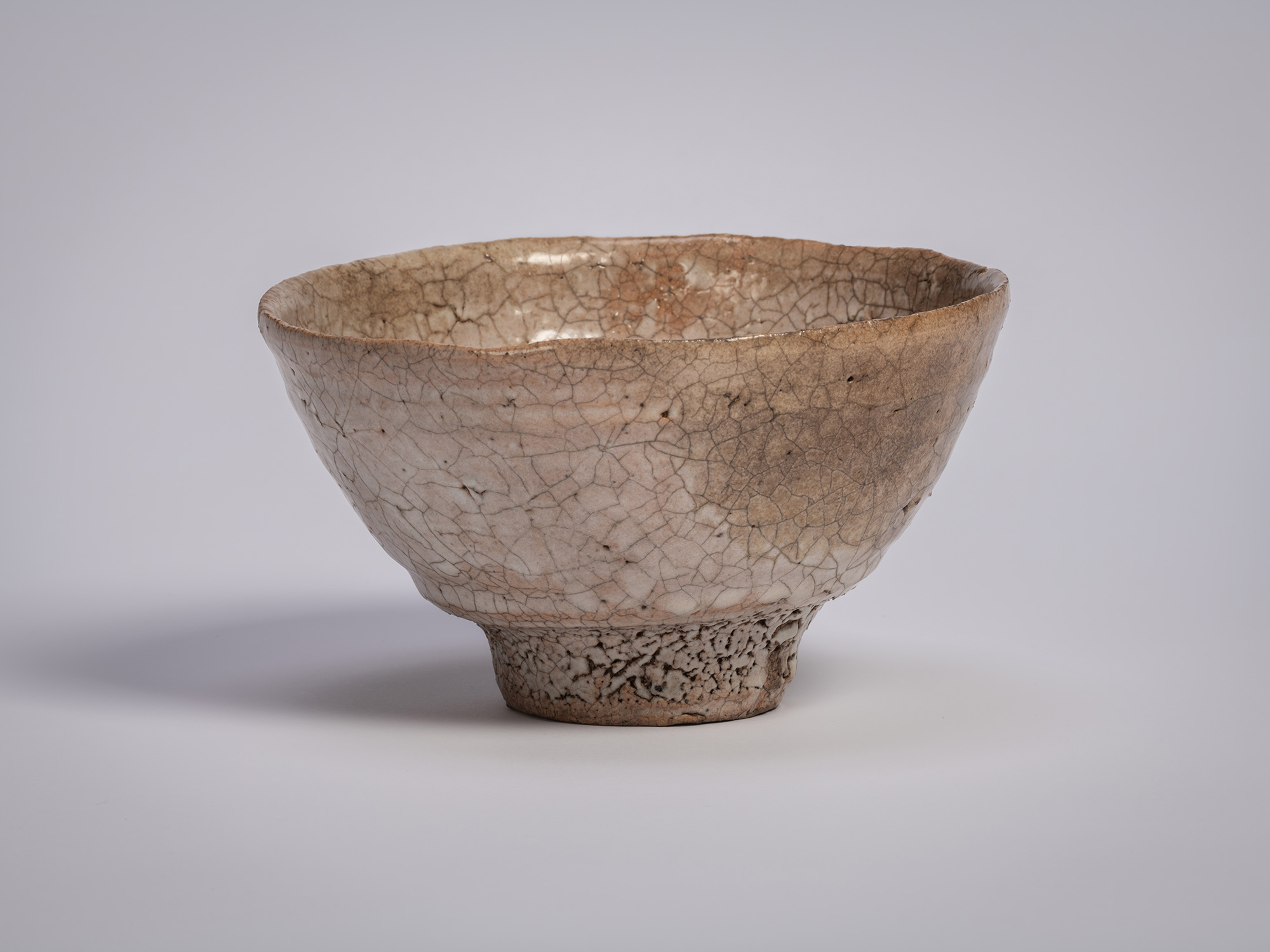 Ido chawan tea bowl by Tsujimura, with an asymmetrical, hand-formed shape, earthy clay body, and...