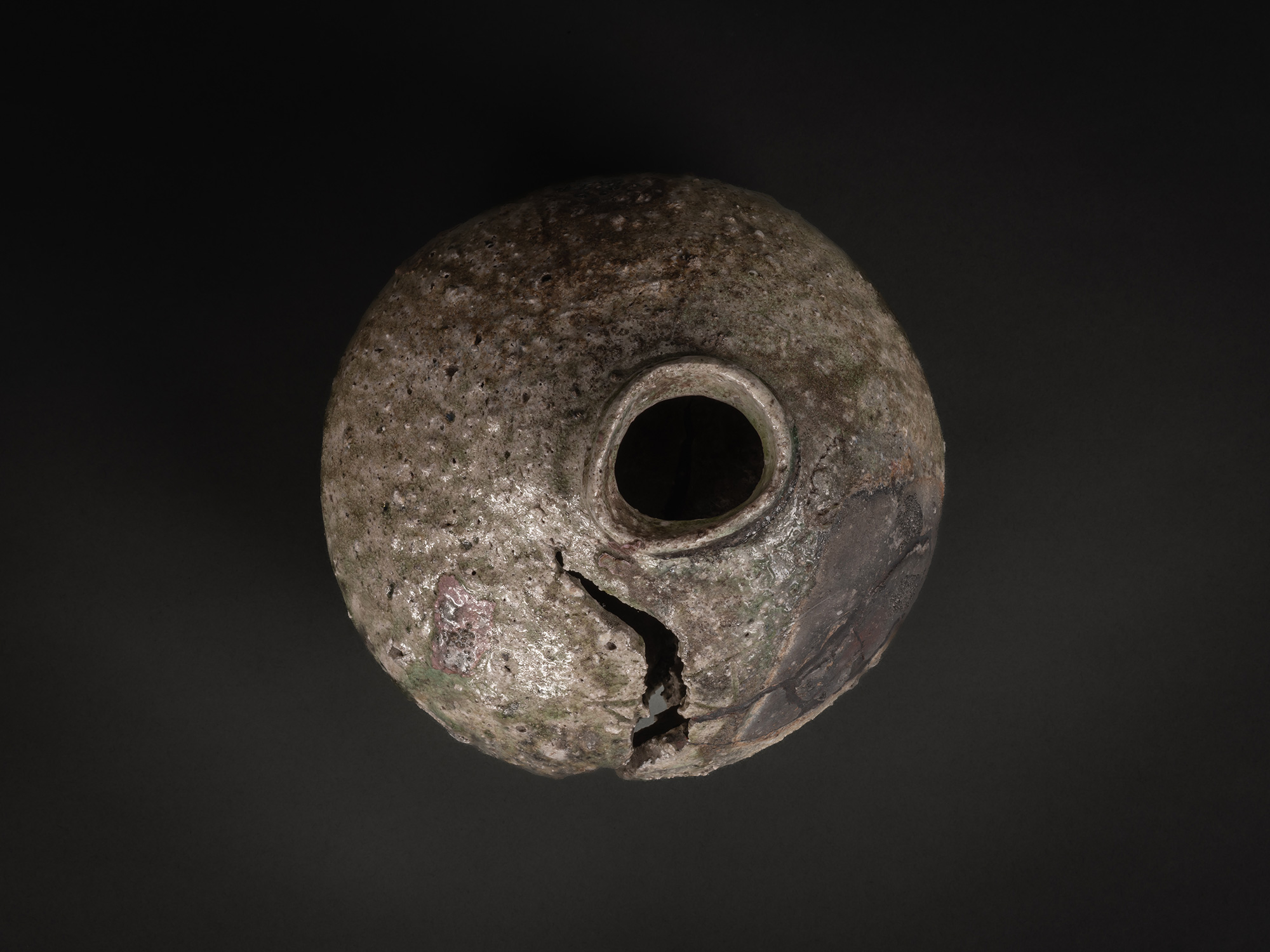Aerial view of Iga Broken Jar by Shiro Tsujimura, showing the circular mouth at center and a rounded,...