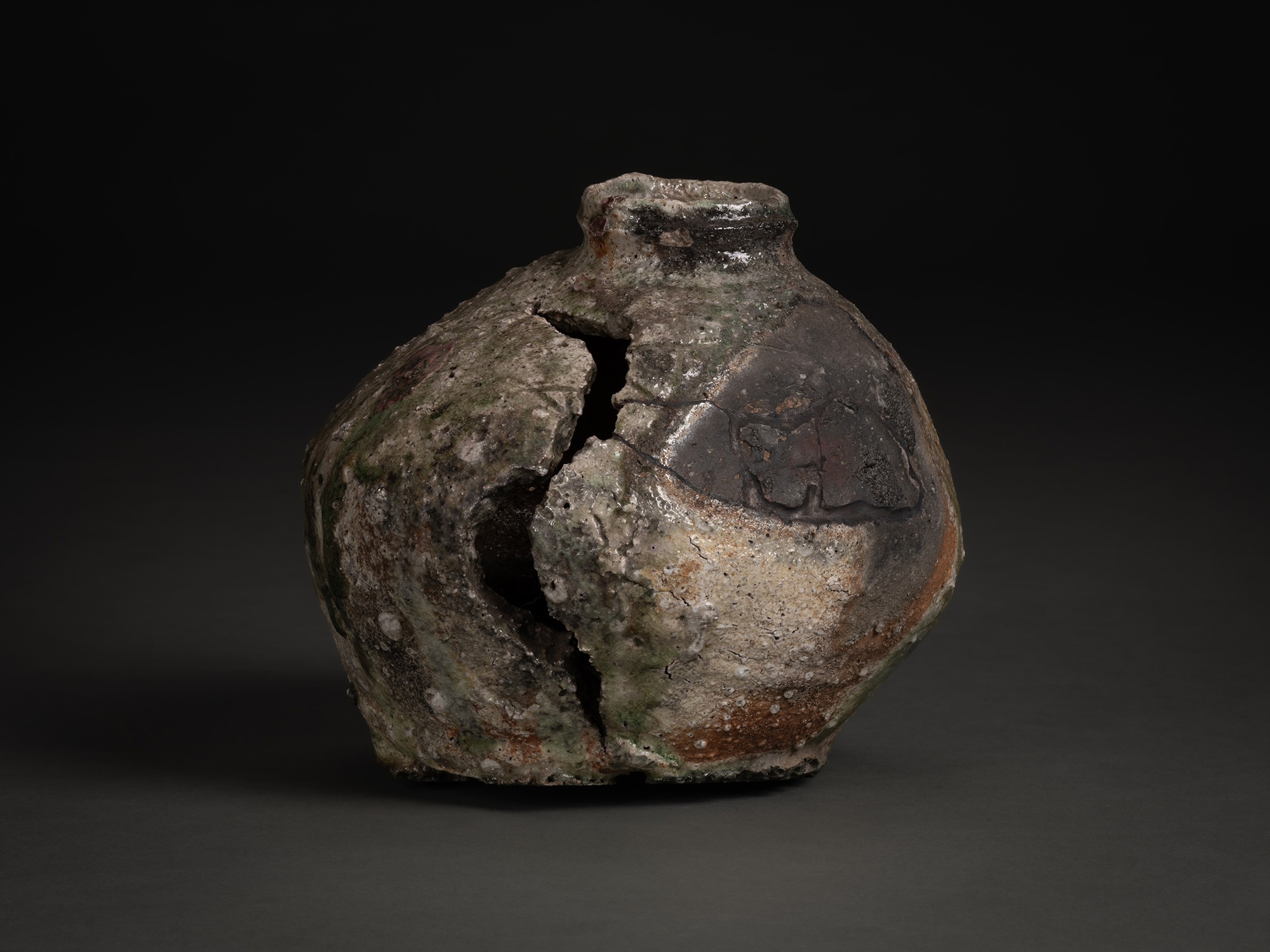 Iga Broken Jar by Shiro Tsujimura, a heavily weathered ceramic vessel with a fractured body, wide...