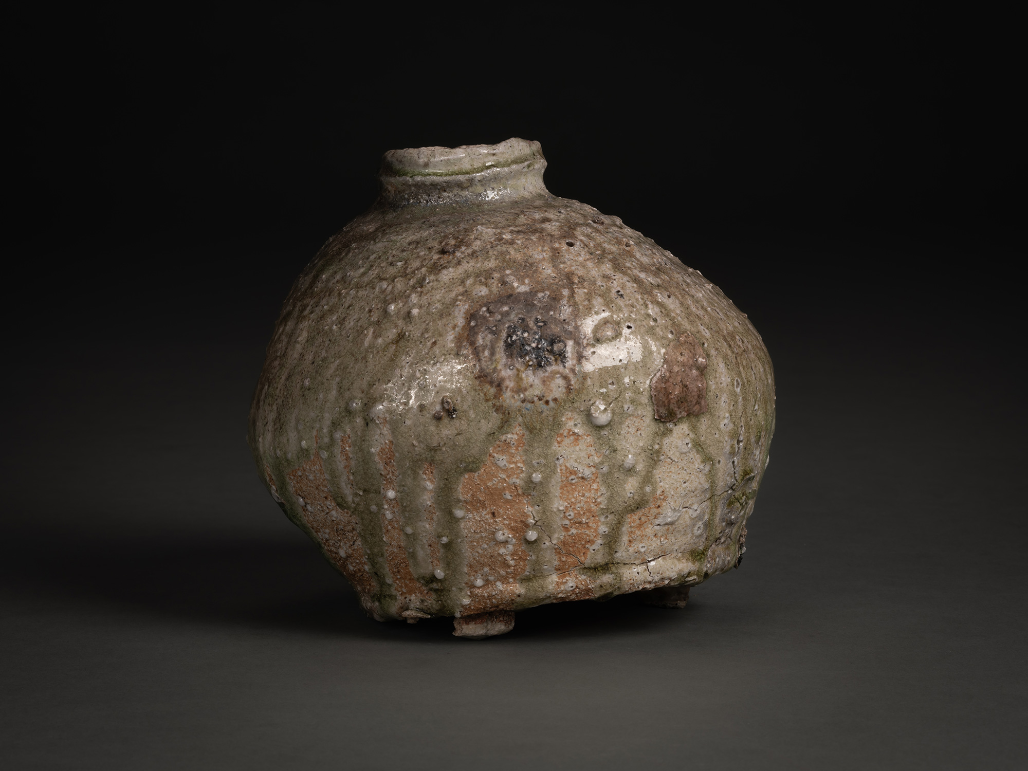 Back view of Iga Broken Jar by Shiro Tsujimura, a rounded ceramic vessel with a short neck and...