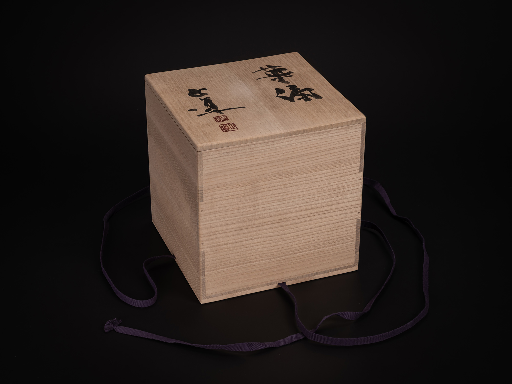 Wooden tomobako storage box for Kayō (Architectural Vessel) by Masamichi Yoshikawa, showing a light...