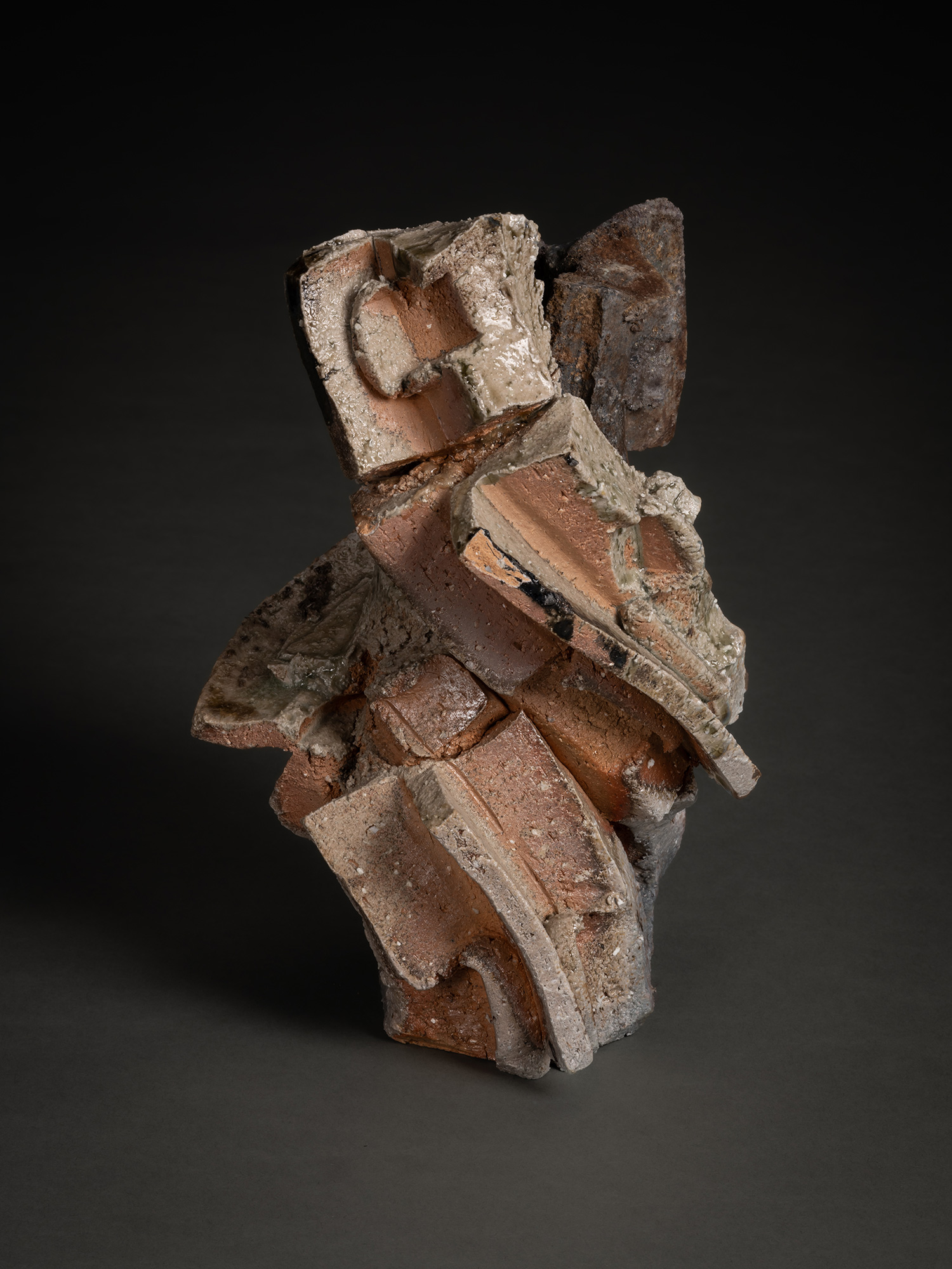 A vertical, multi-layered stoneware sculpture by Shozo Michikawa featuring a stack of sharp, protruding...