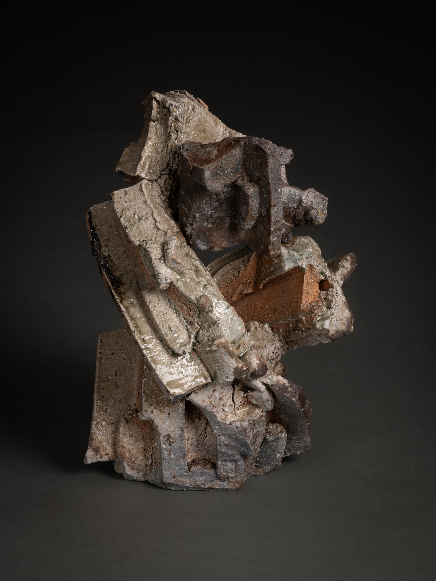 A vertical, multi-layered stoneware sculpture by Shozo Michikawa featuring a stack of sharp, protruding...