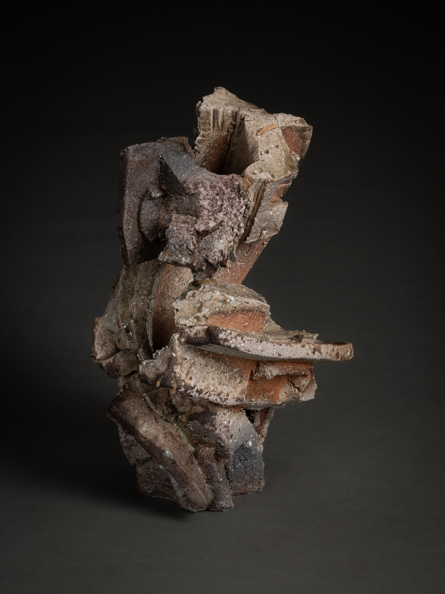 A vertical, multi-layered stoneware sculpture by Shozo Michikawa featuring a stack of sharp, protruding...