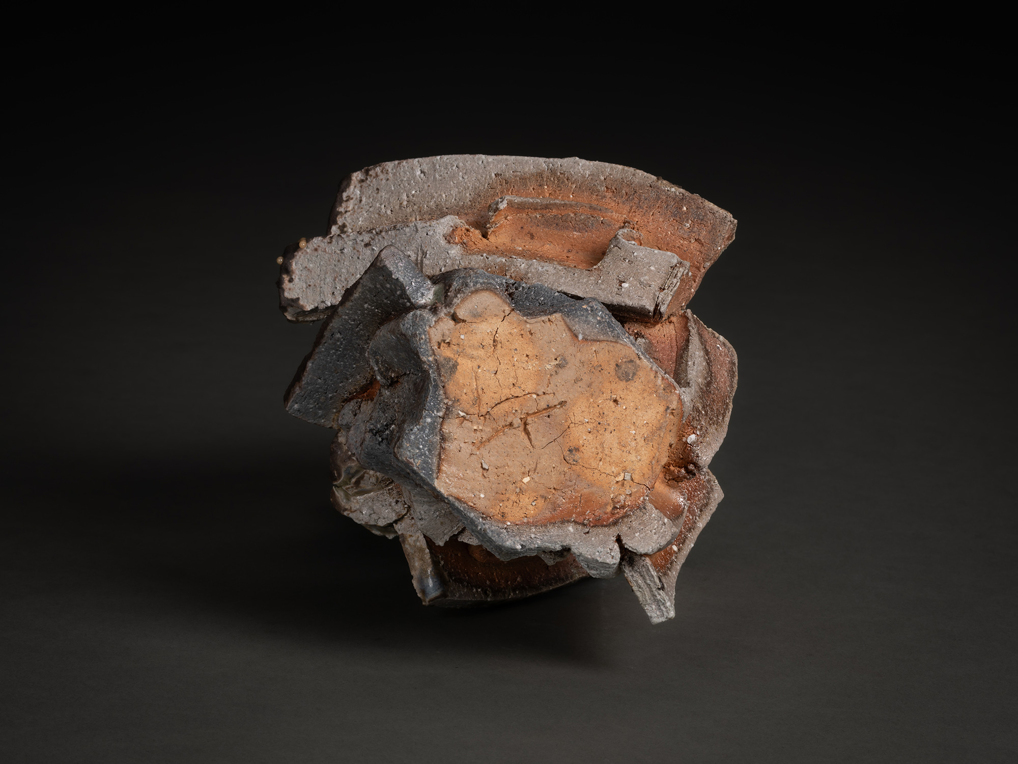An overhead aerial view looking down into the hollow, dark core of a Shozo Michikawa sculpture....