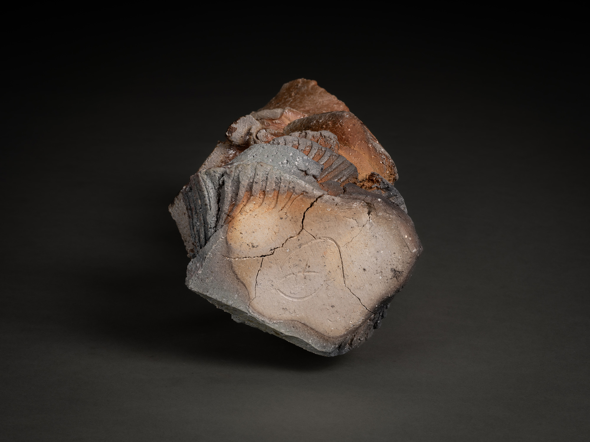 Foot of a natural ash sculptural ceramic by Shōzō Michikawa, showing an irregular, roughly cut...