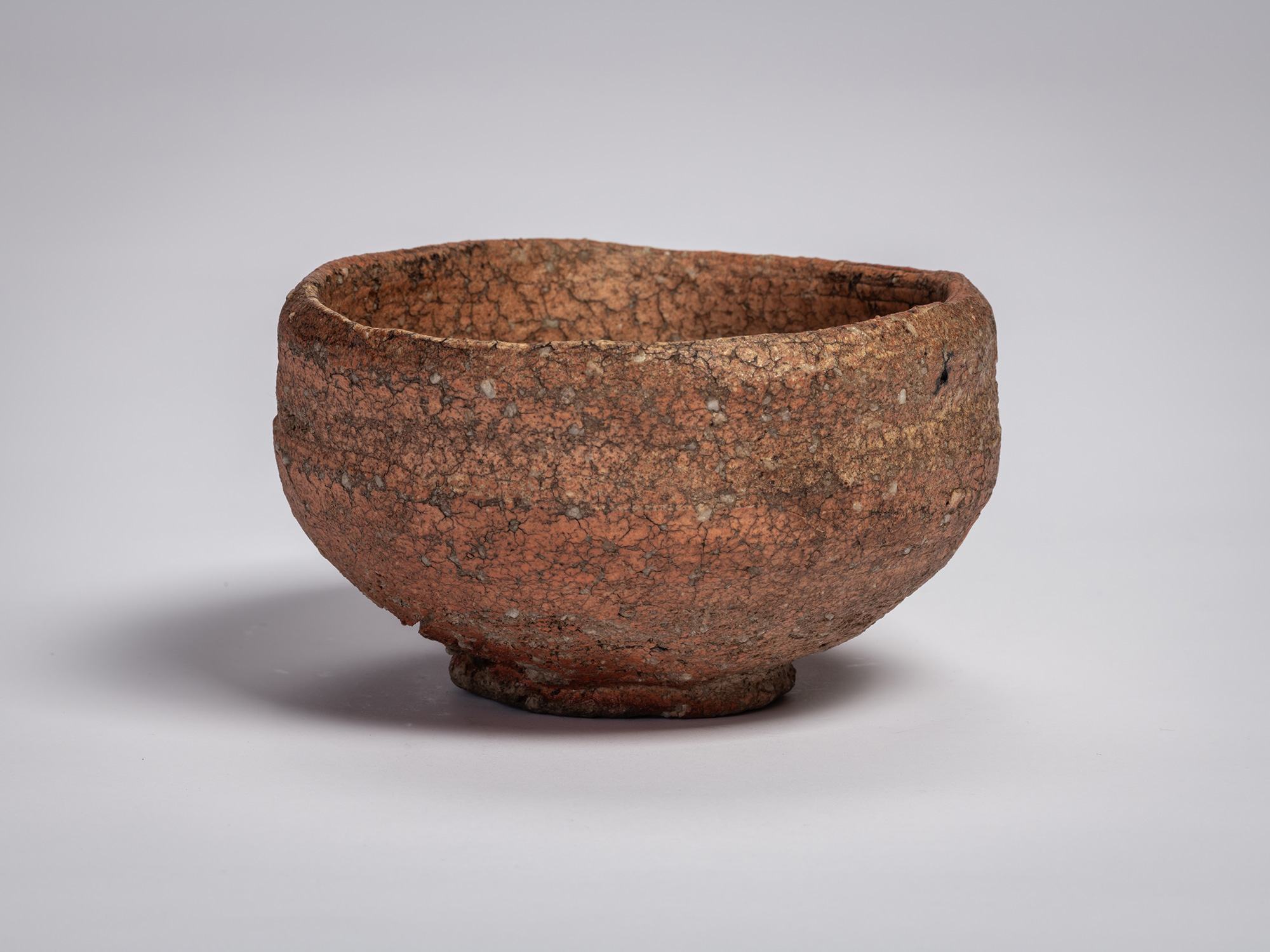 Shigaraki chawan tea bowl by Tsujimura with a rounded, slightly irregular form, featuring a rough,...
