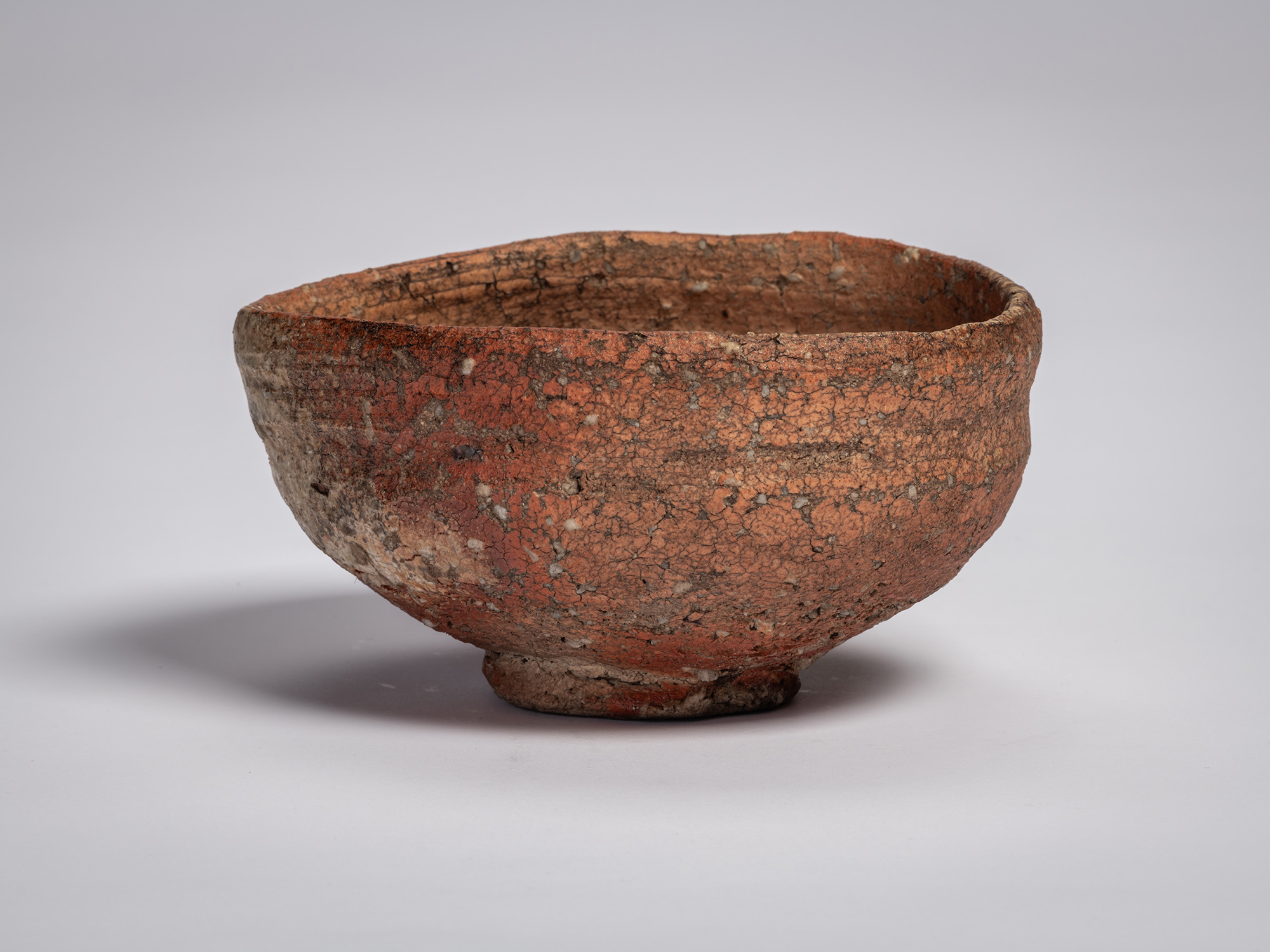 Shigaraki chawan tea bowl by Tsujimura with a rounded, slightly irregular form, featuring a rough,...
