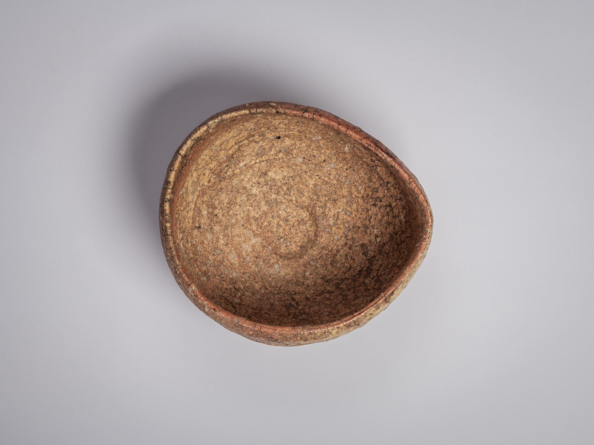 Interior of a Shigaraki chawan by Tsujimura, showing a rounded bowl form with a coarse, granular...
