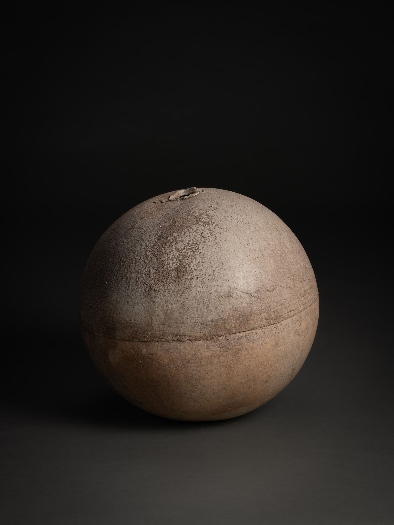 Sphere by Tsujimura, a rounded ceramic form with a near-perfect spherical silhouette, shown against...