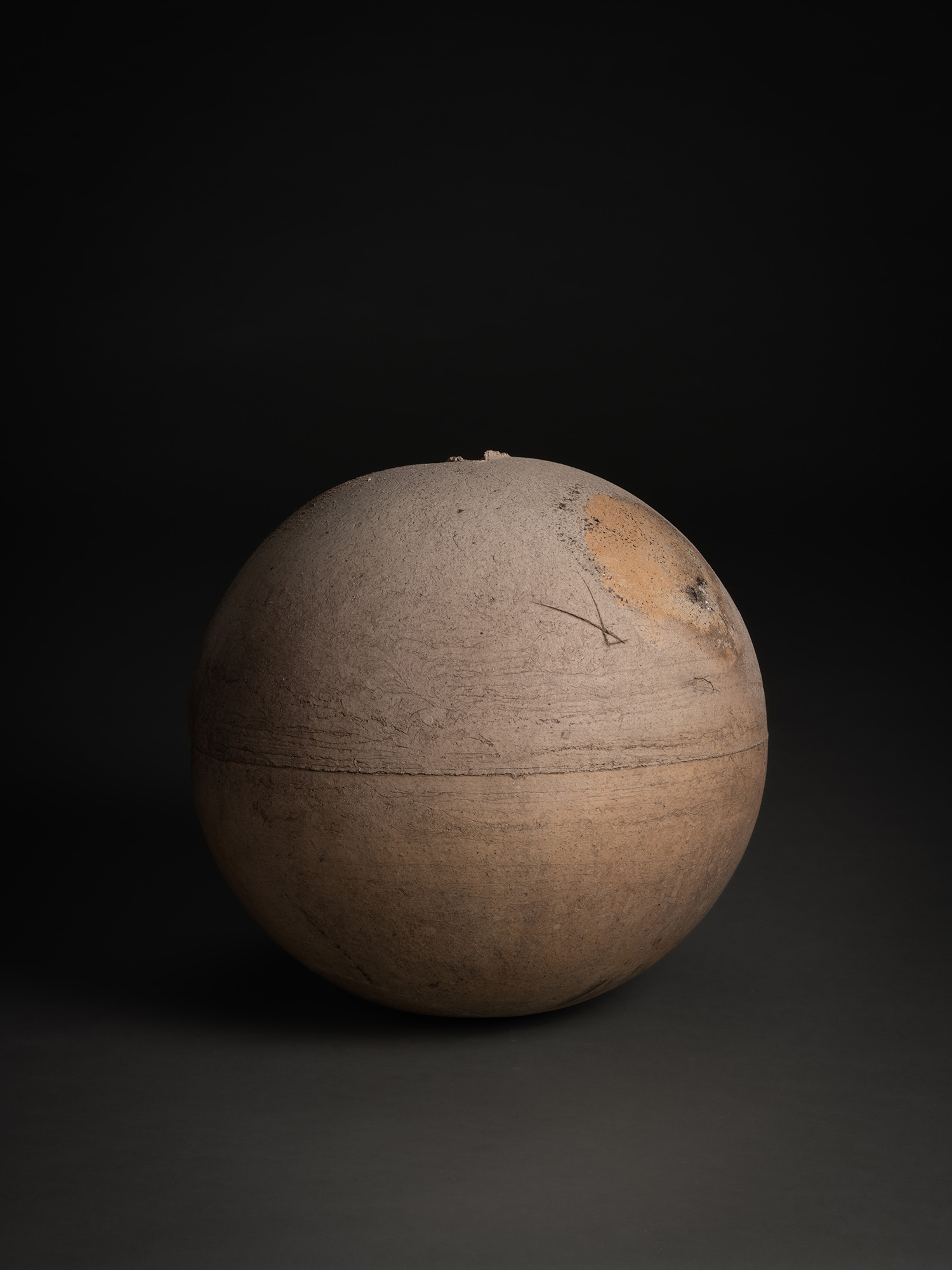 Sphere by Tsujimura, a rounded ceramic form with a near-perfect spherical silhouette, shown against...