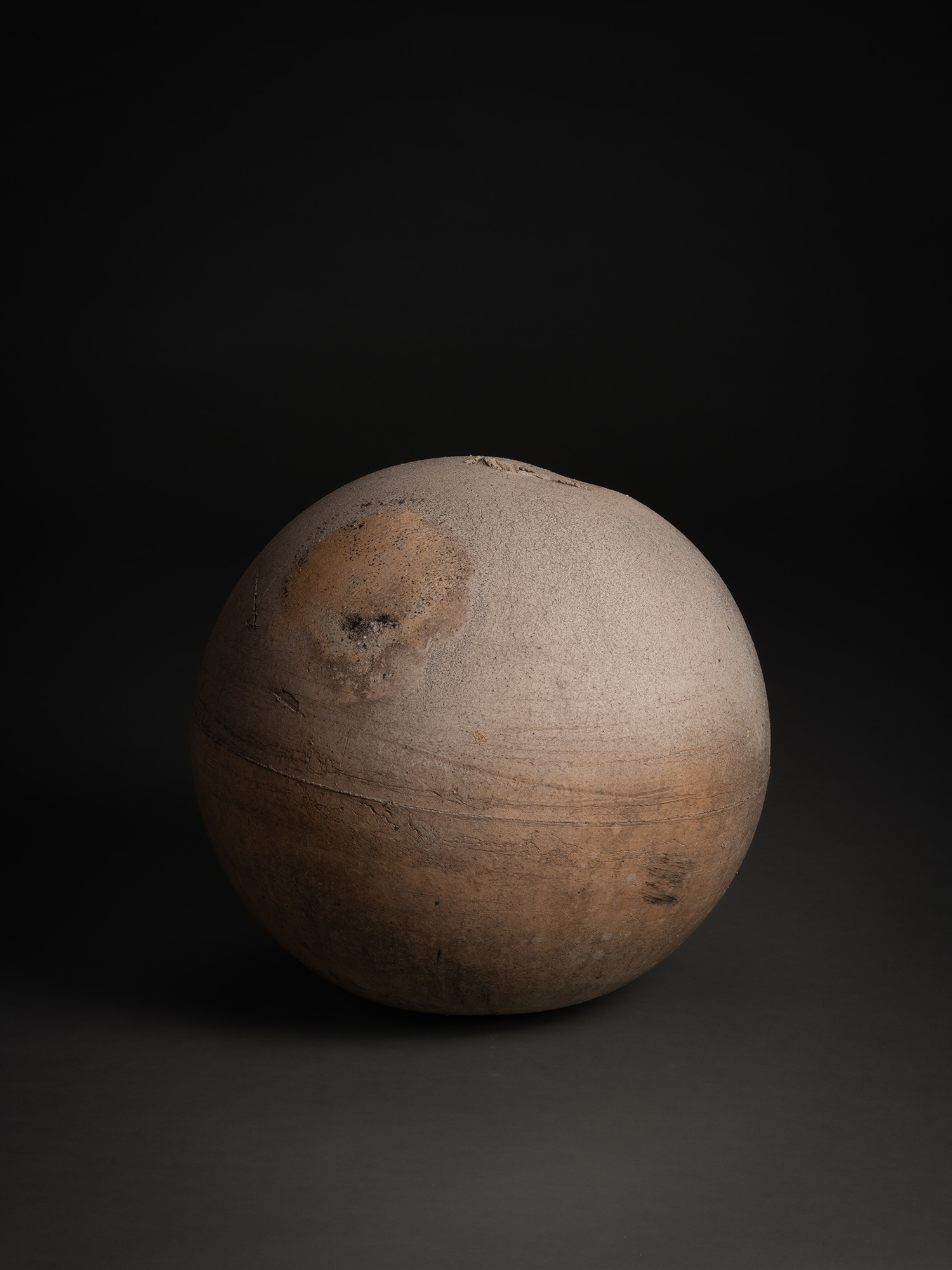 Sphere by Tsujimura, a rounded ceramic form with a near-perfect spherical silhouette, shown against...