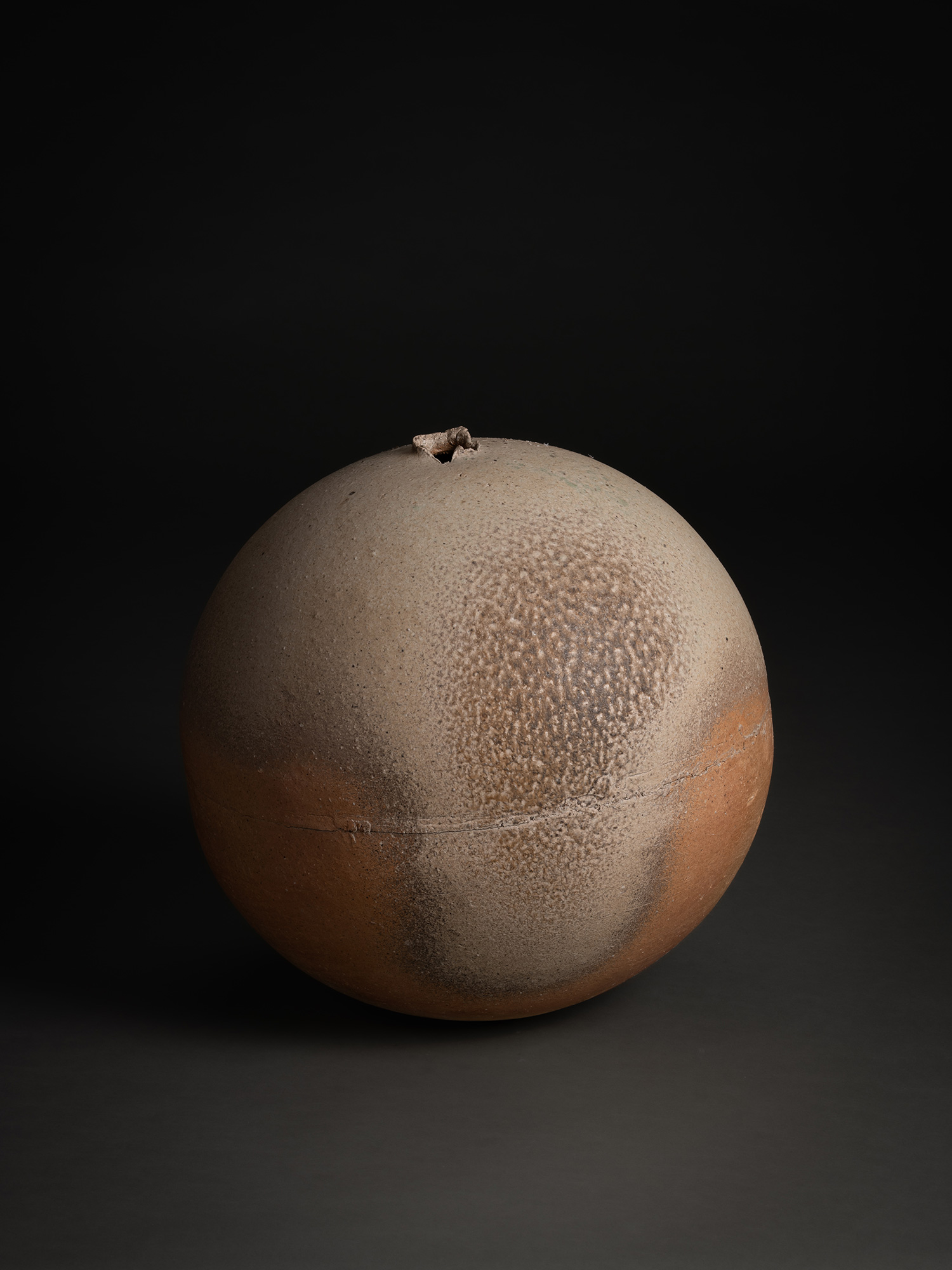 Sphere by Tsujimura, a hand-formed ceramic with a rounded, near-spherical shape, shown against...