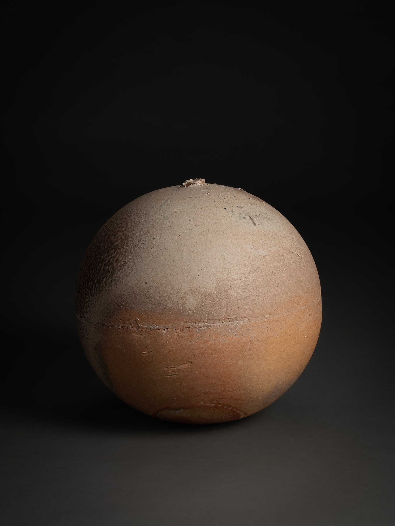 Sphere by Tsujimura, a hand-formed ceramic with a rounded, near-spherical shape, shown against...
