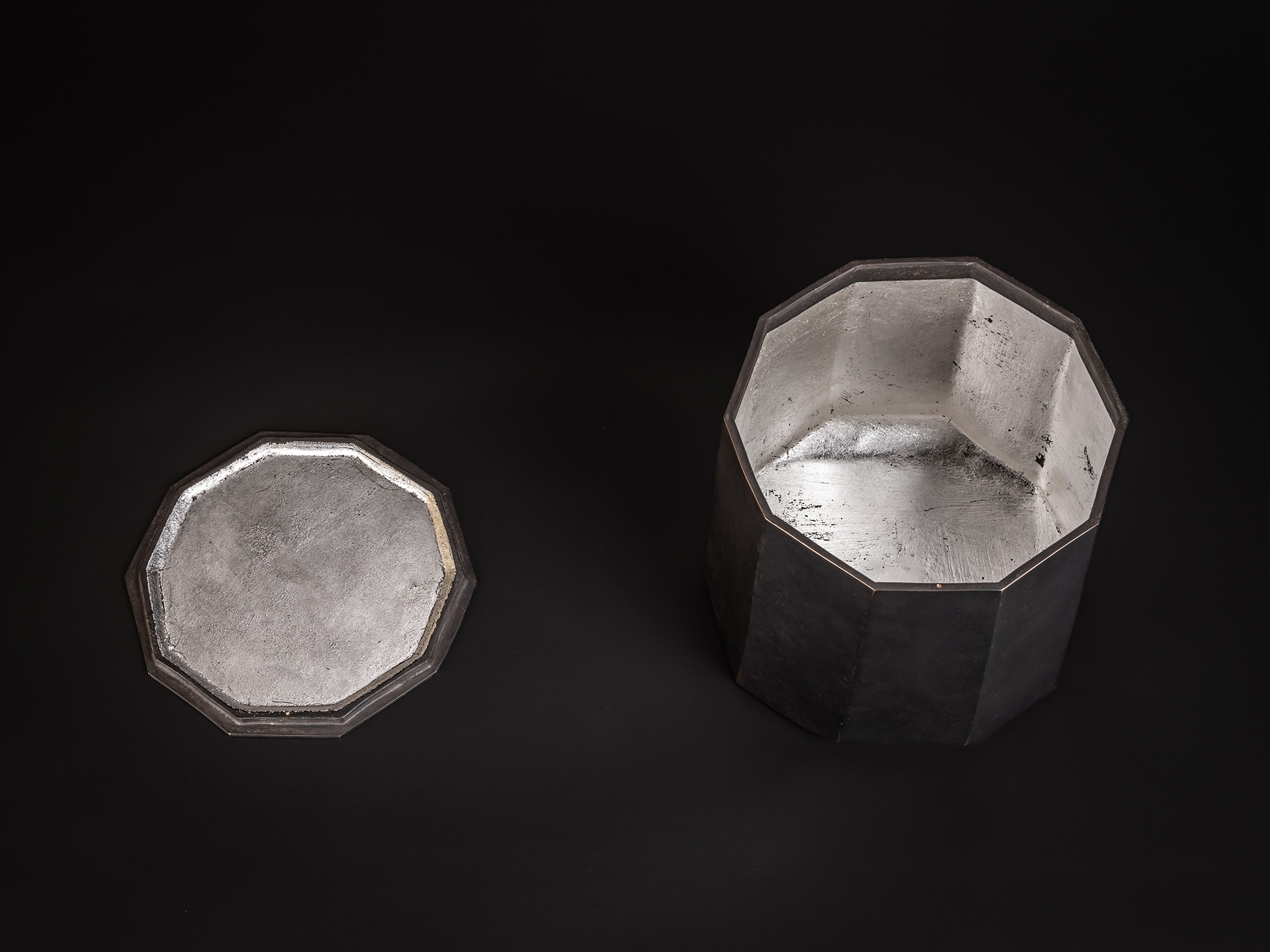 Aerial view of faceted bronze vessel titled Ten Faces II by Koji Hatakeyama, shown with its lid...