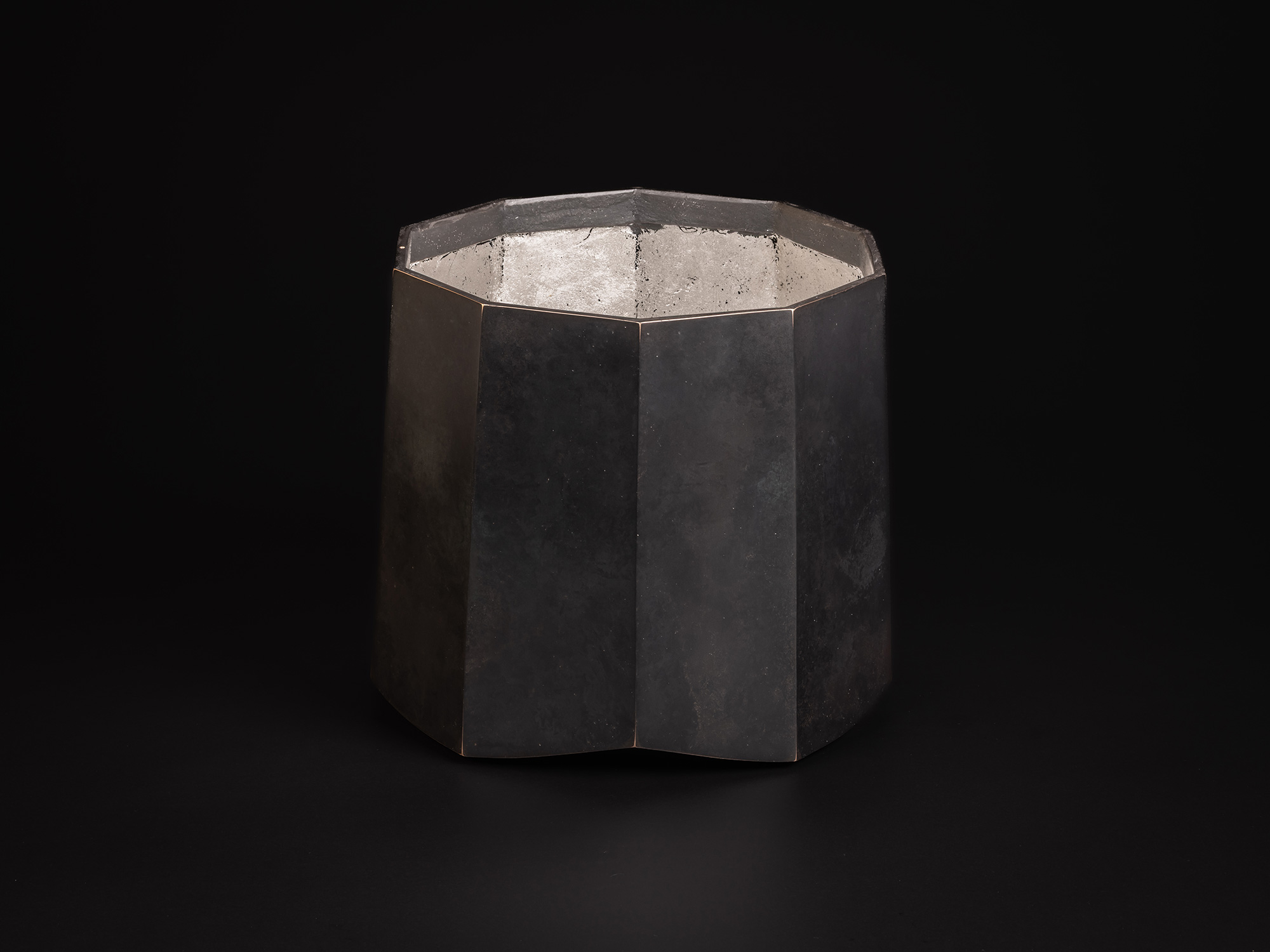 Faceted bronze vessel titled Ten Faces II by Koji Hatakeyama, with a decagonal form composed of...