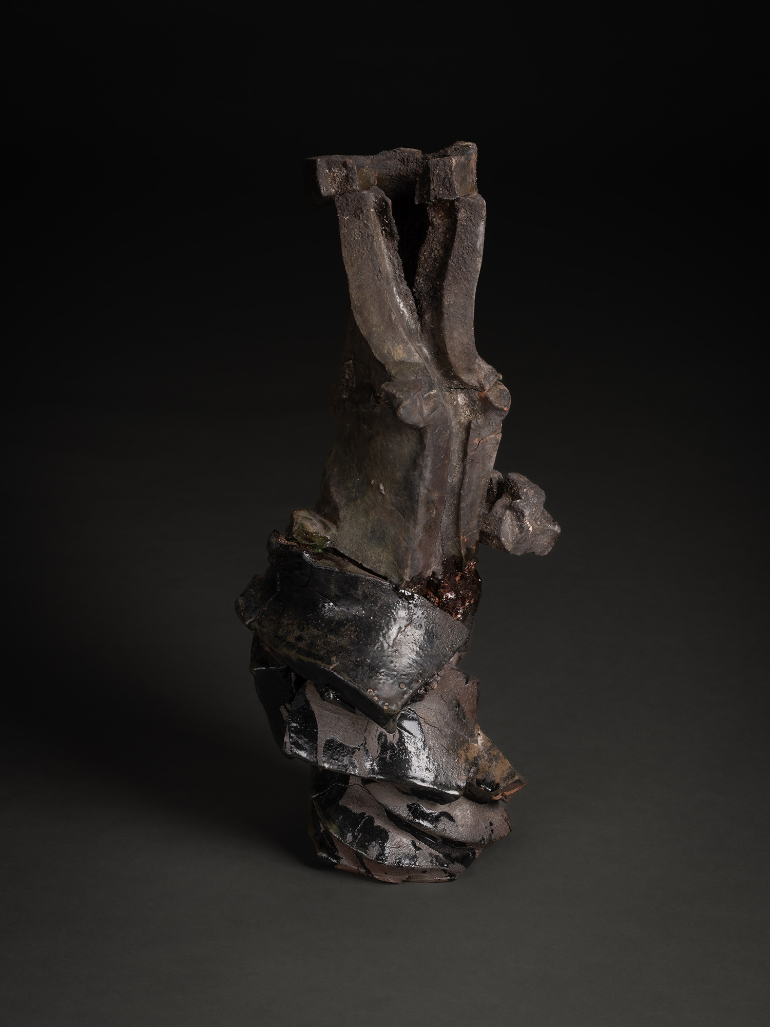 Vertical ceramic sculpture titled Volcano by Shōzō Michikawa, composed of stacked, fractured planes...