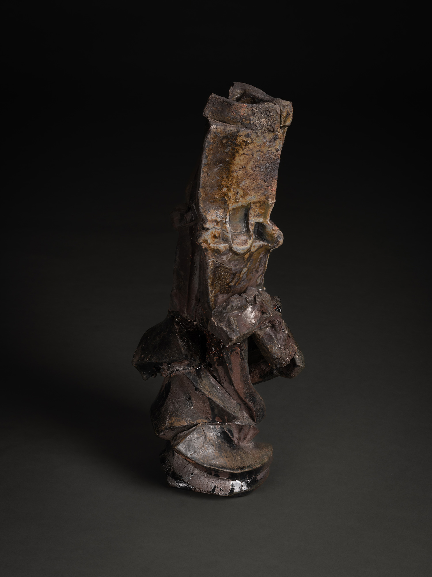 Vertical ceramic sculpture titled Volcano by Shōzō Michikawa, composed of stacked, fractured planes...