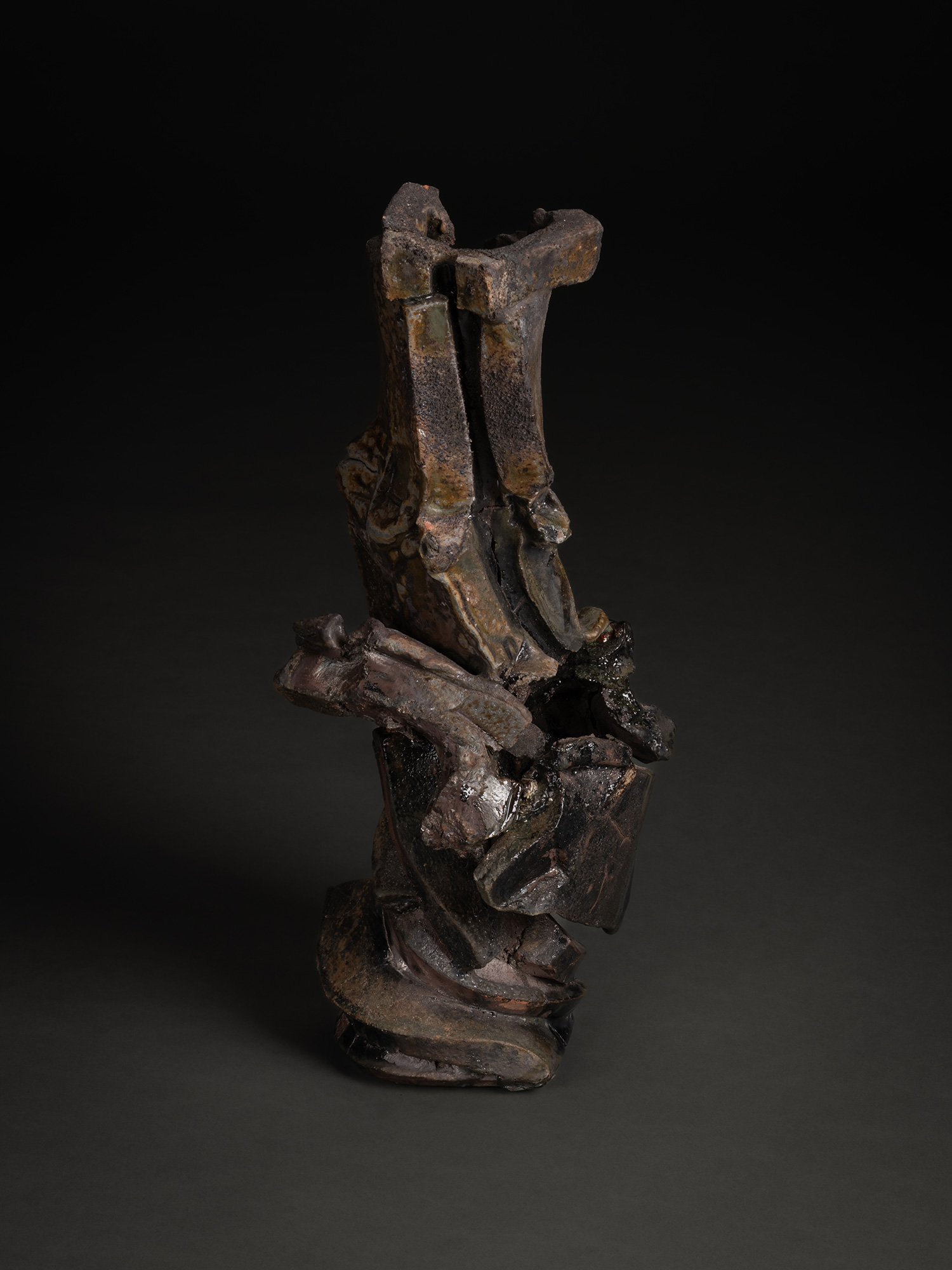 Vertical ceramic sculpture titled Volcano by Shōzō Michikawa, composed of stacked, fractured planes...