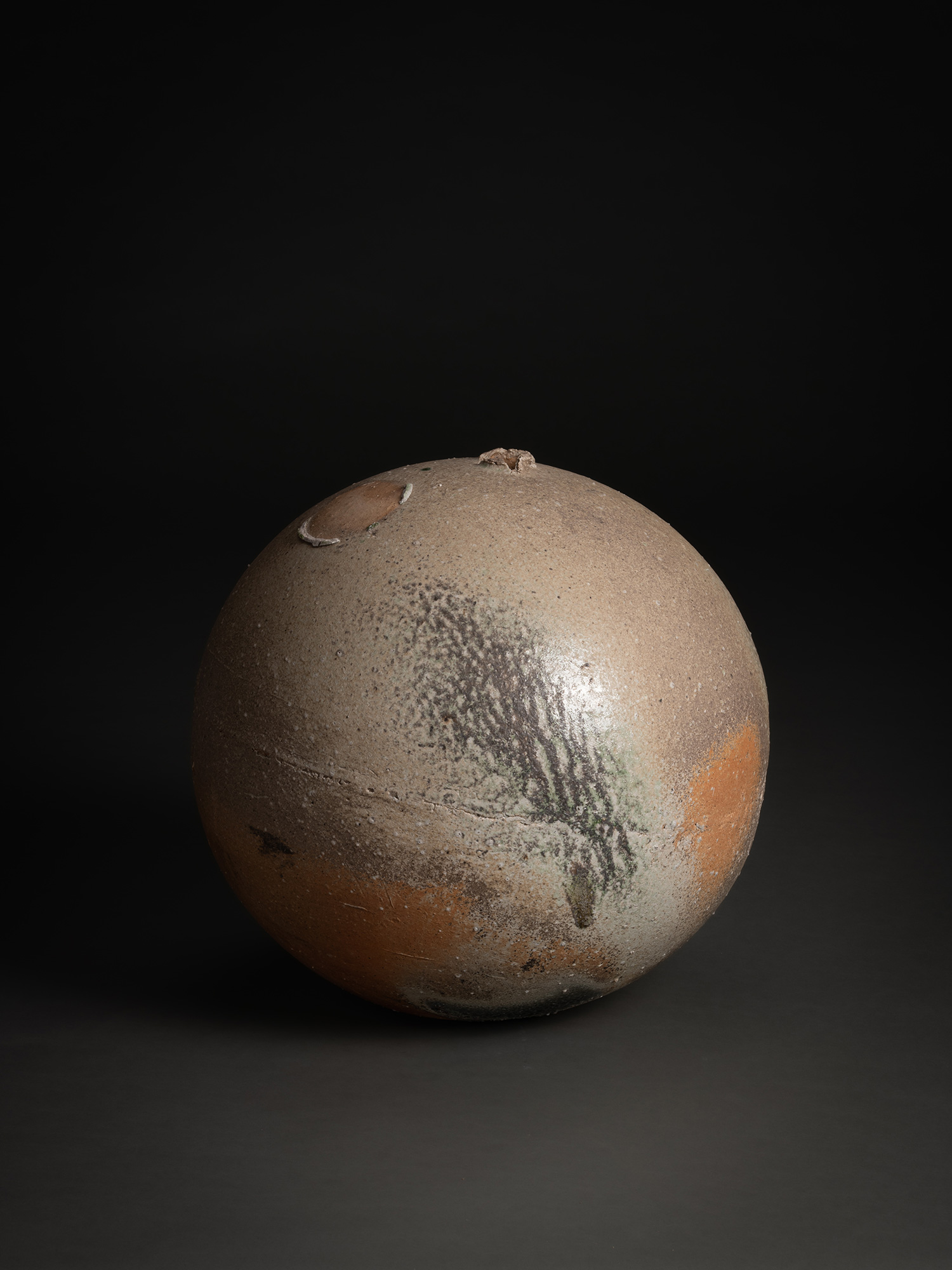Sphere by Tsujimura, a hand-formed ceramic with a rounded, near-spherical shape, shown against...