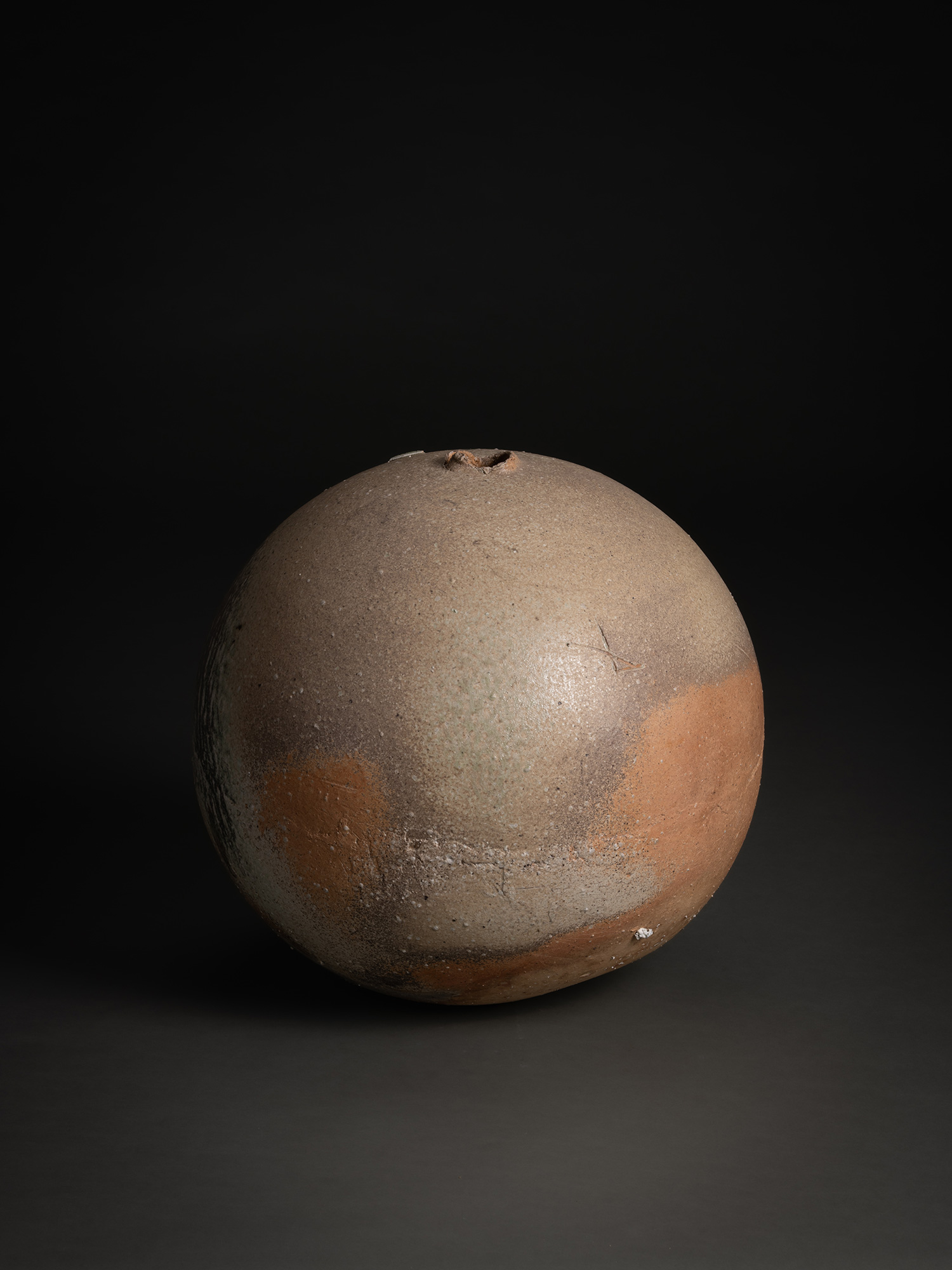 Sphere by Tsujimura, a hand-formed ceramic with a rounded, near-spherical shape, shown against...