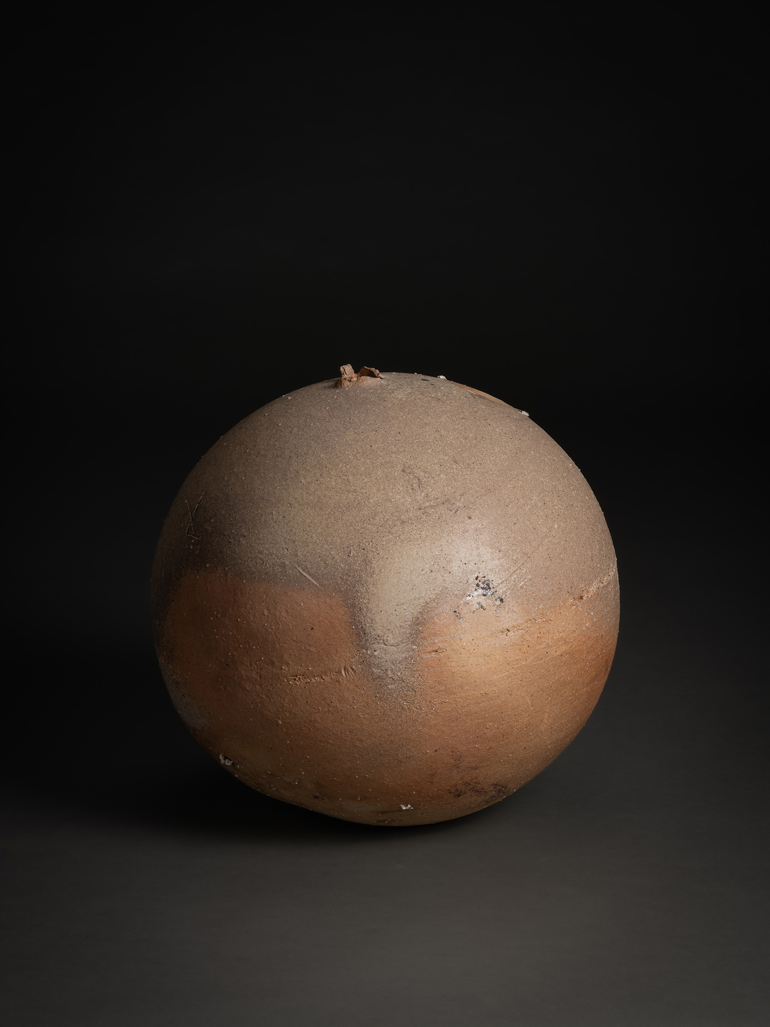 Sphere by Tsujimura, a hand-formed ceramic with a rounded, near-spherical shape, shown against...