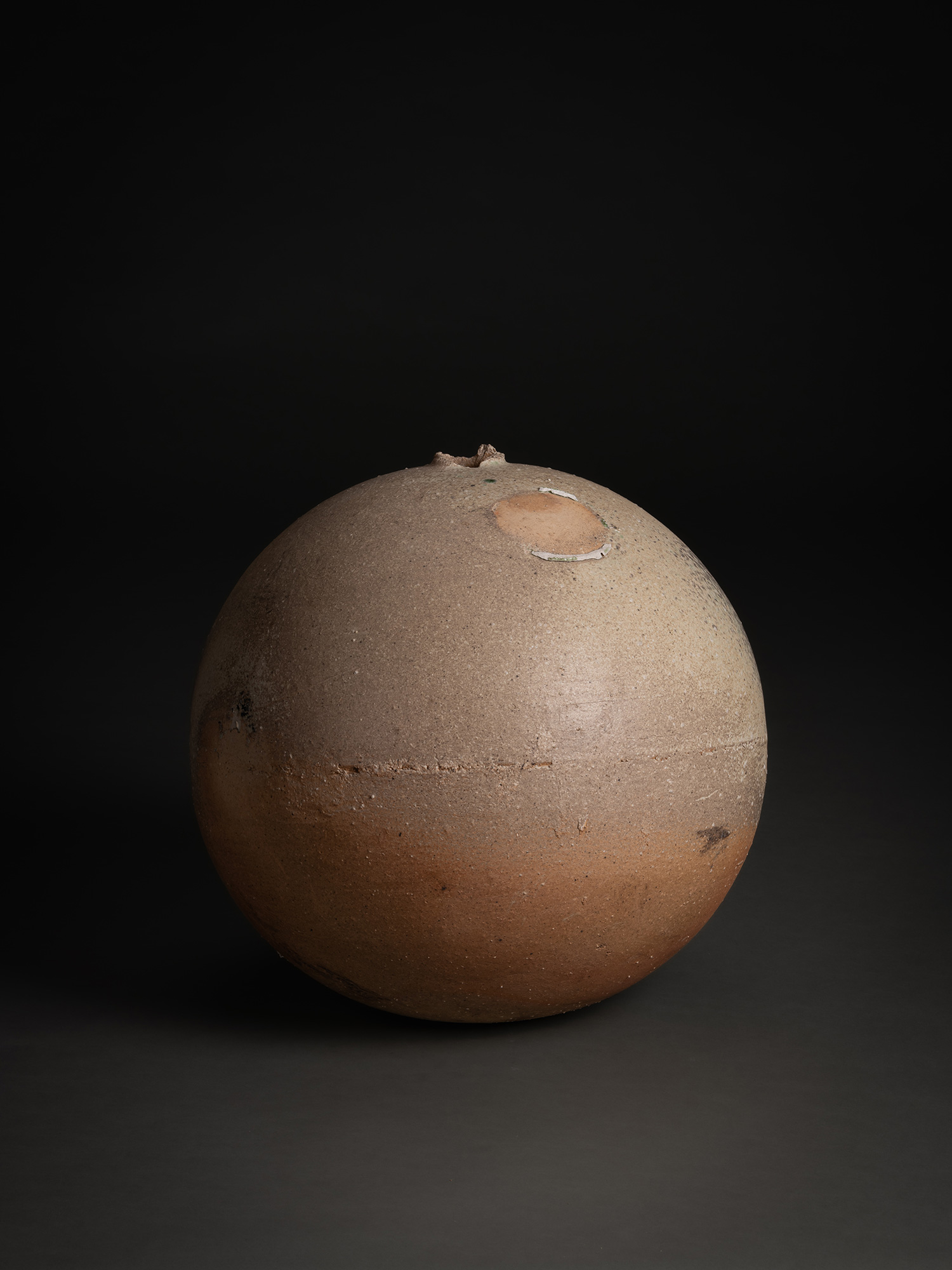 Sphere by Tsujimura, a hand-formed ceramic with a rounded, near-spherical shape, shown against...